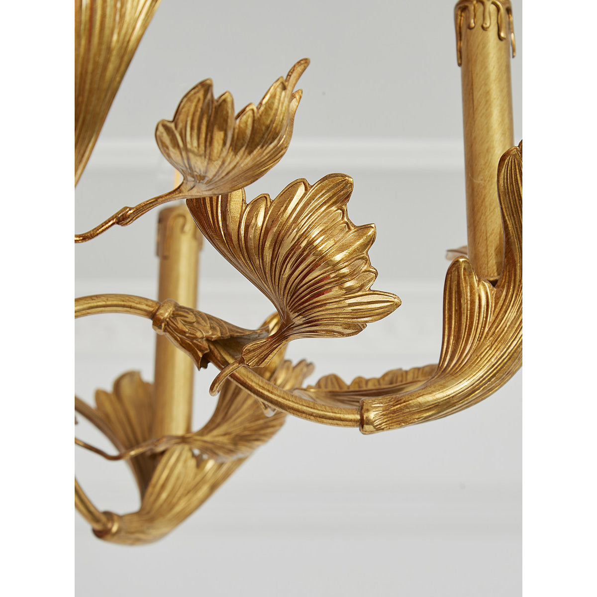 The 6-head version of the chandelier hanging above a small dining table.