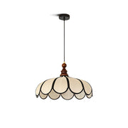 Botan Pendant Light with a scalloped abaca shade and black trim.