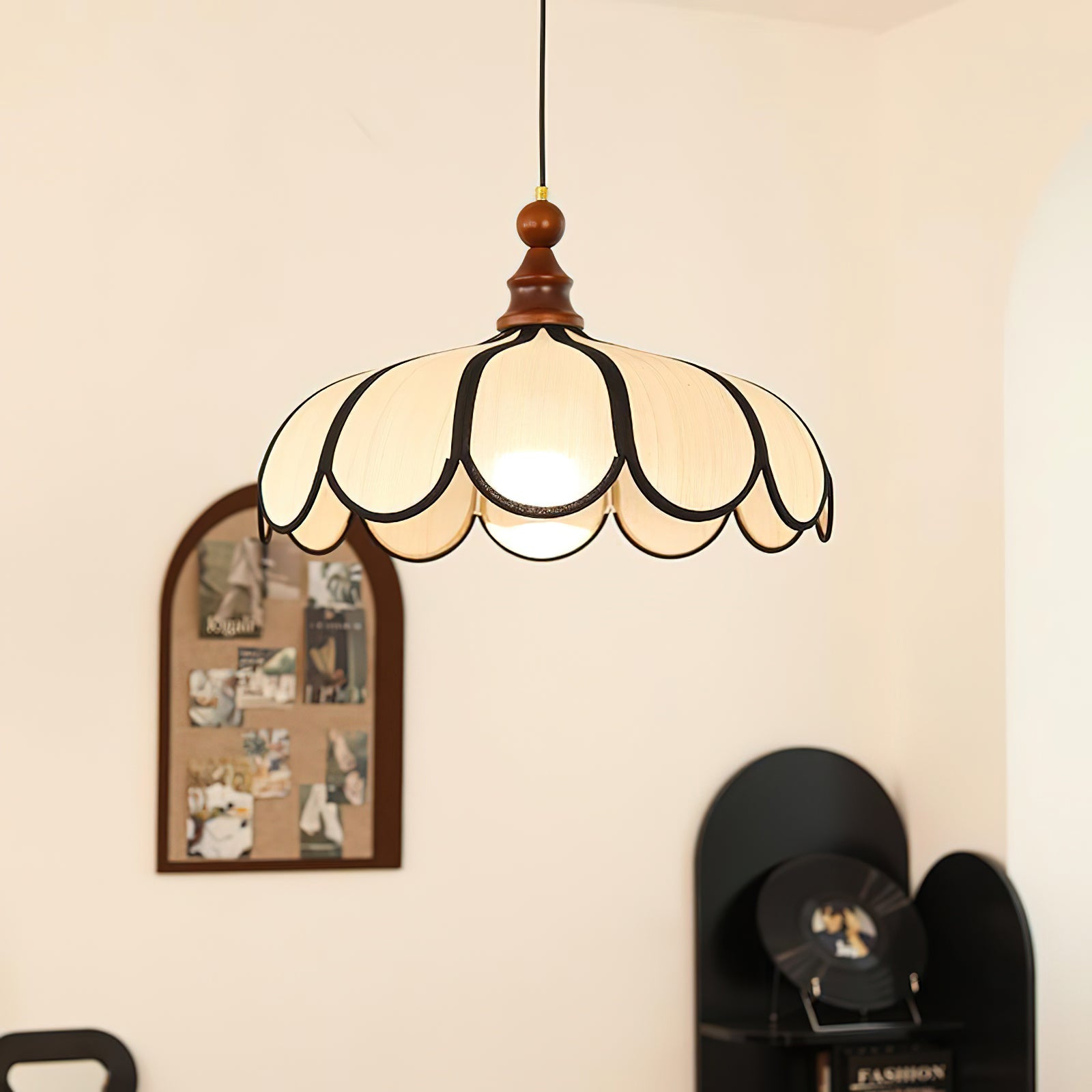 Botan Pendant Light hanging above a wooden dining table.