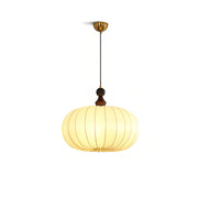 Bowie Pendant Light with a white fabric shade and wood accents in a modern living room.