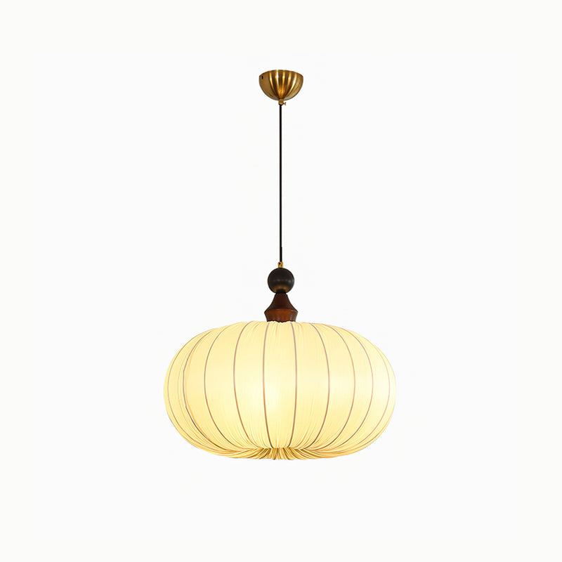 The gold and white version of the Bowie Pendant Light against a dark wall.
