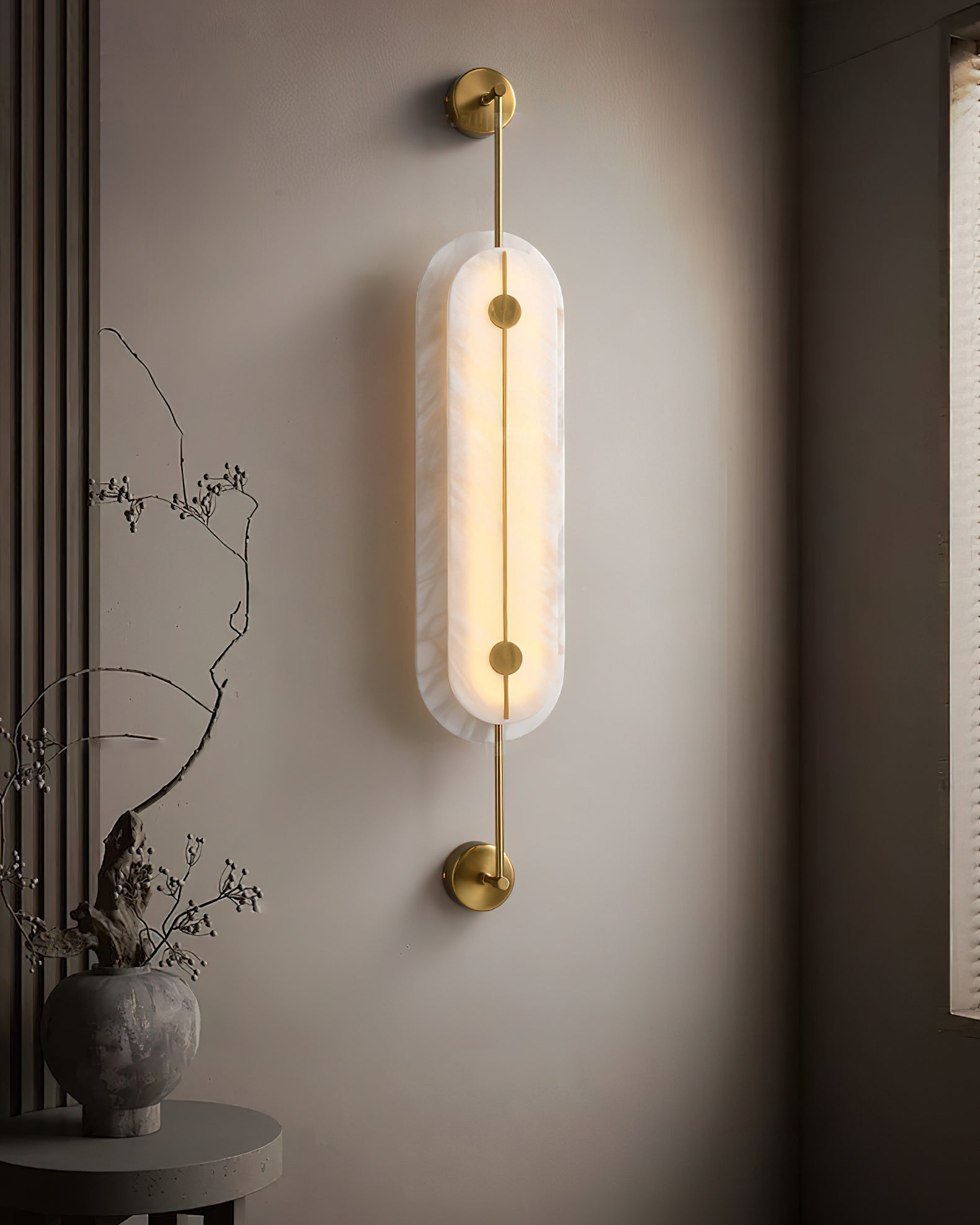 The medium size variant of the Brace Alabaster Wall Lamp.