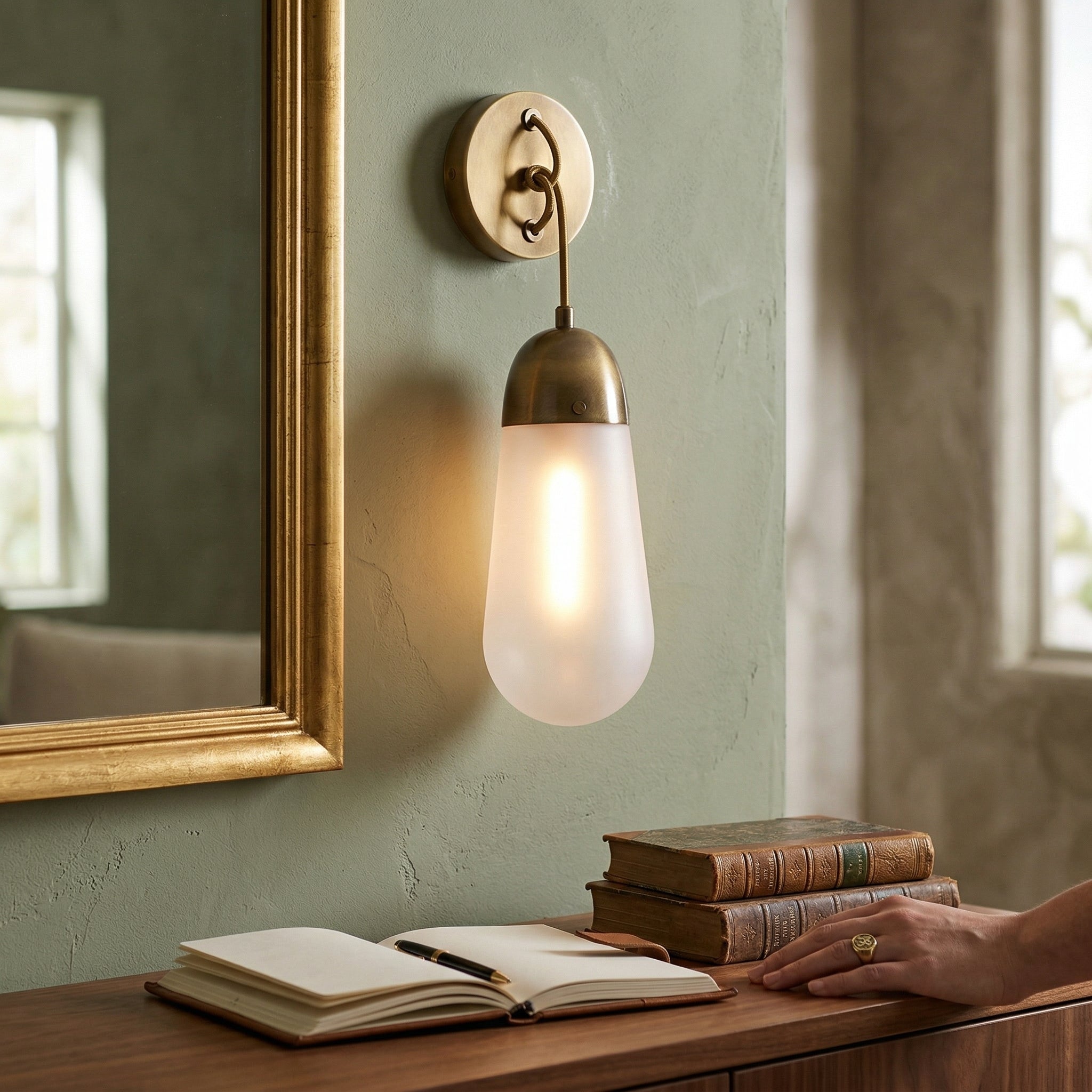 Two Lariat Wall Lamps in bronze flanking a bathroom mirror.