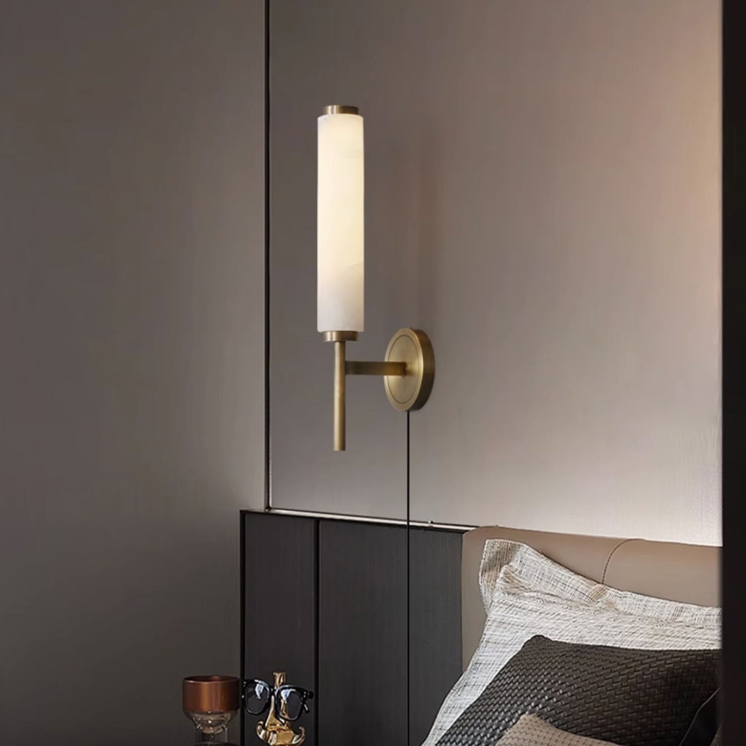 The Brindisi Wall Lamp shown in a living room setting, casting a warm glow.