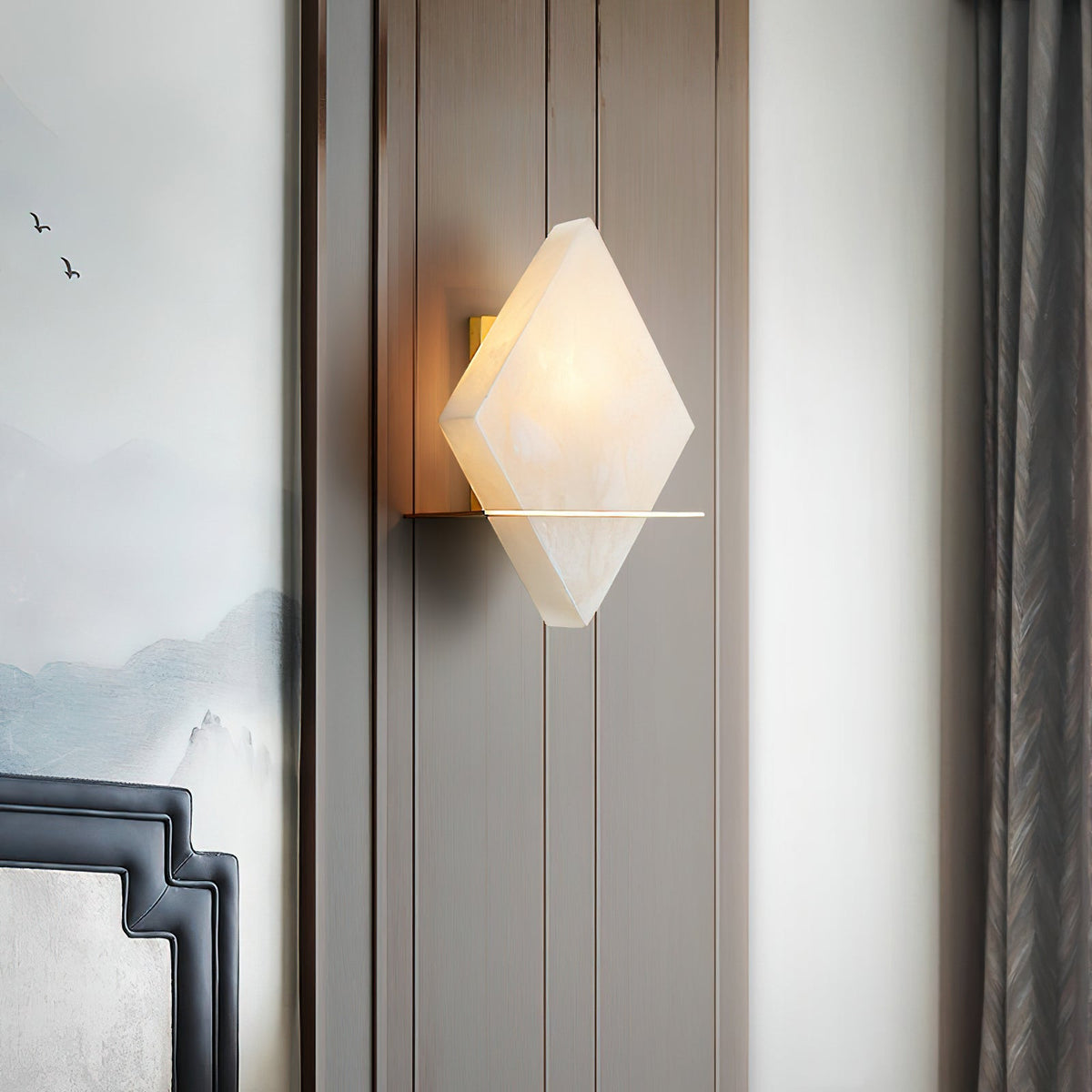 The Brockton Wall Lamp illuminated, showing its warm glow through the alabaster.