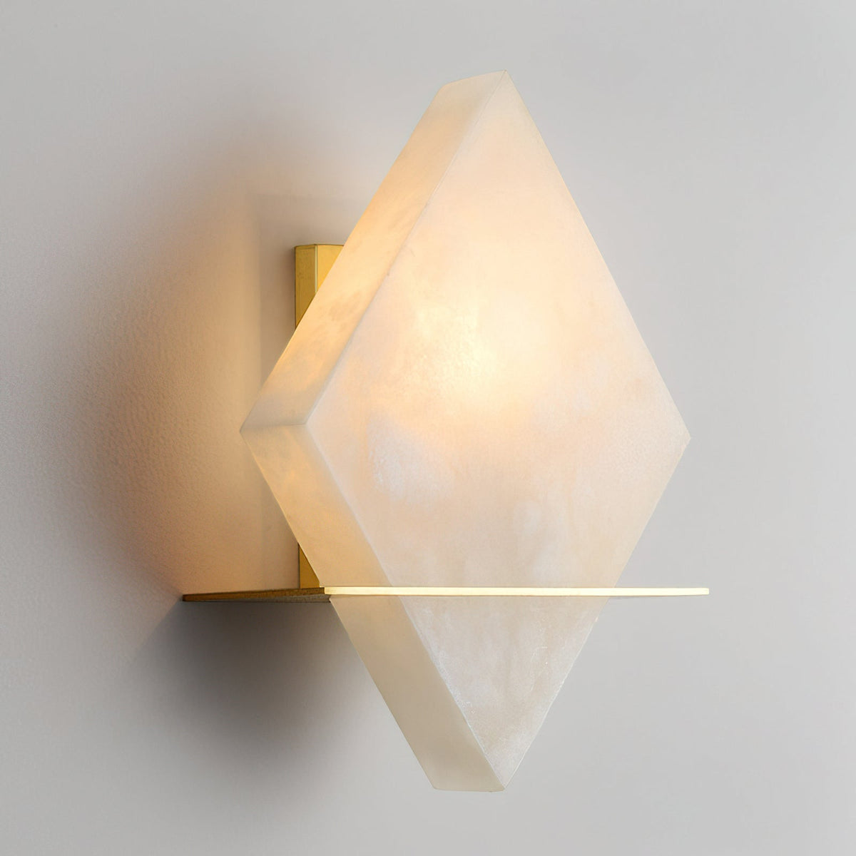 Detail shot of the warm brass fixture of the Brockton Wall Lamp.