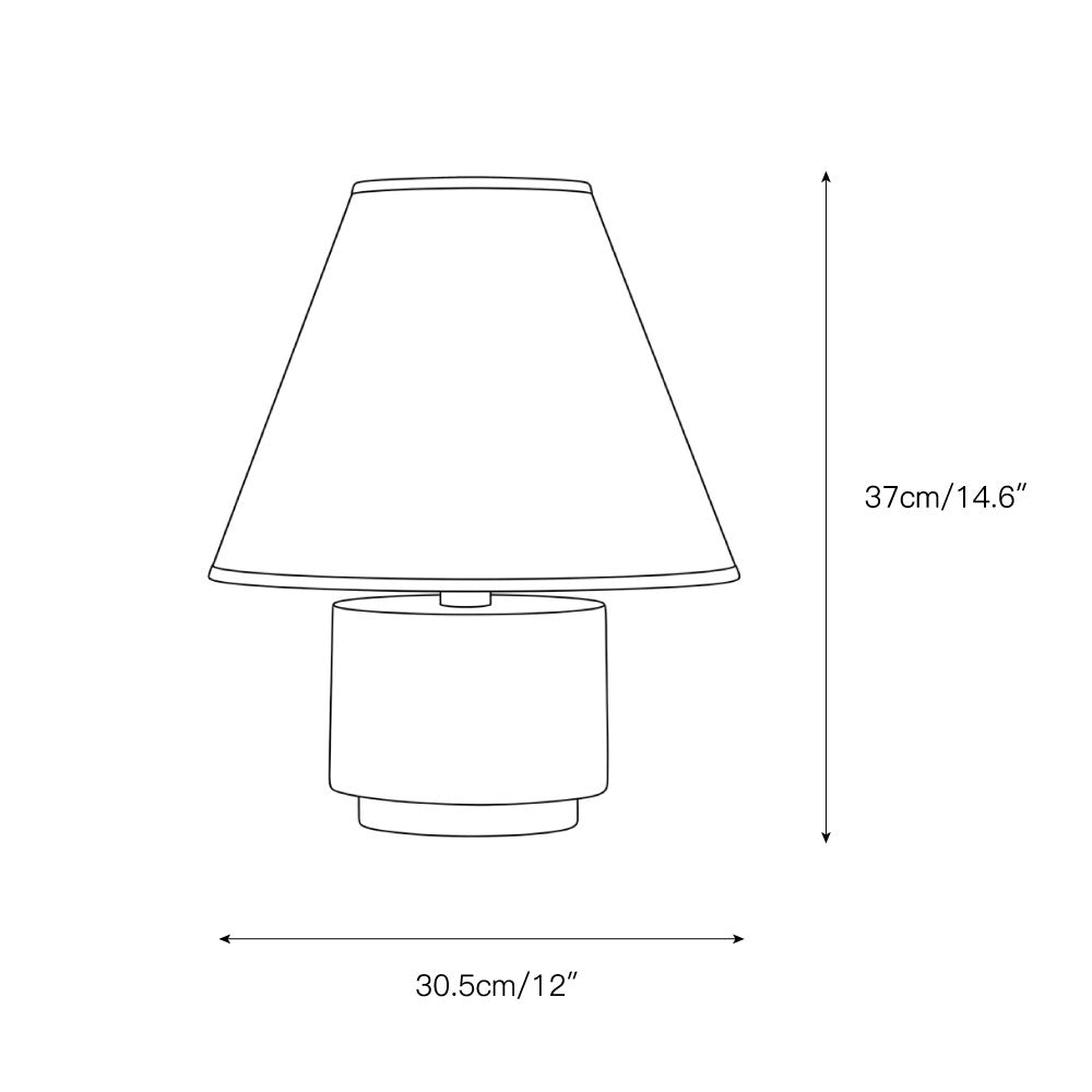 The Bronte Table Lamp shown on a living room end table.