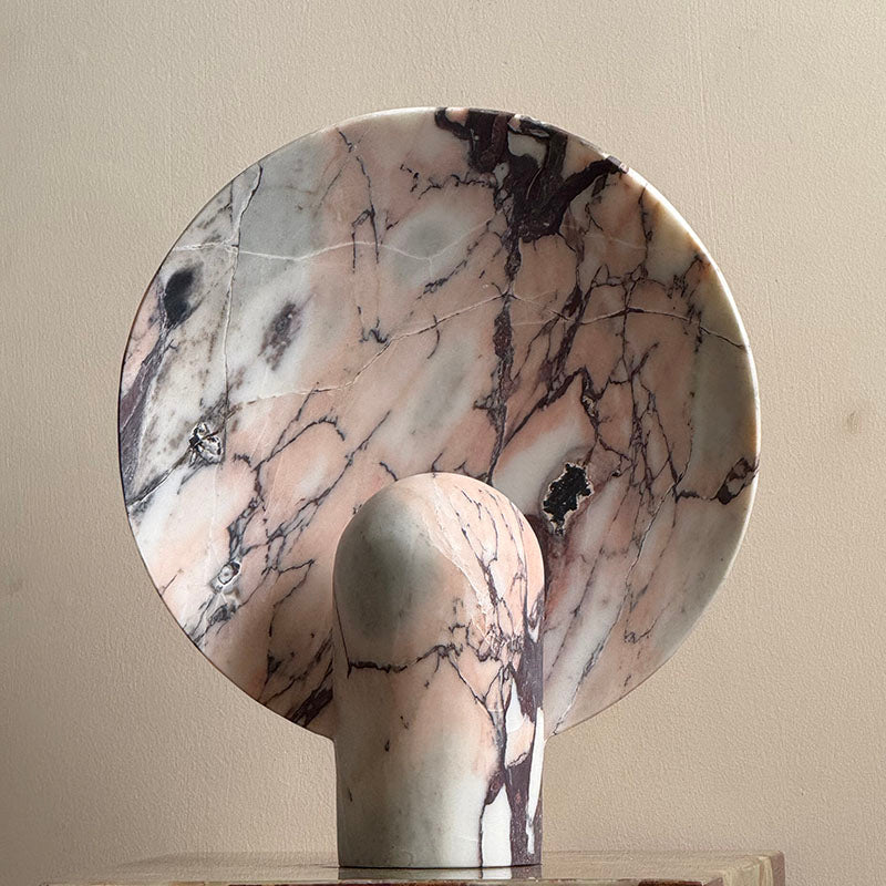The cyan onyx Fan Table Lamp illuminating a dark room.