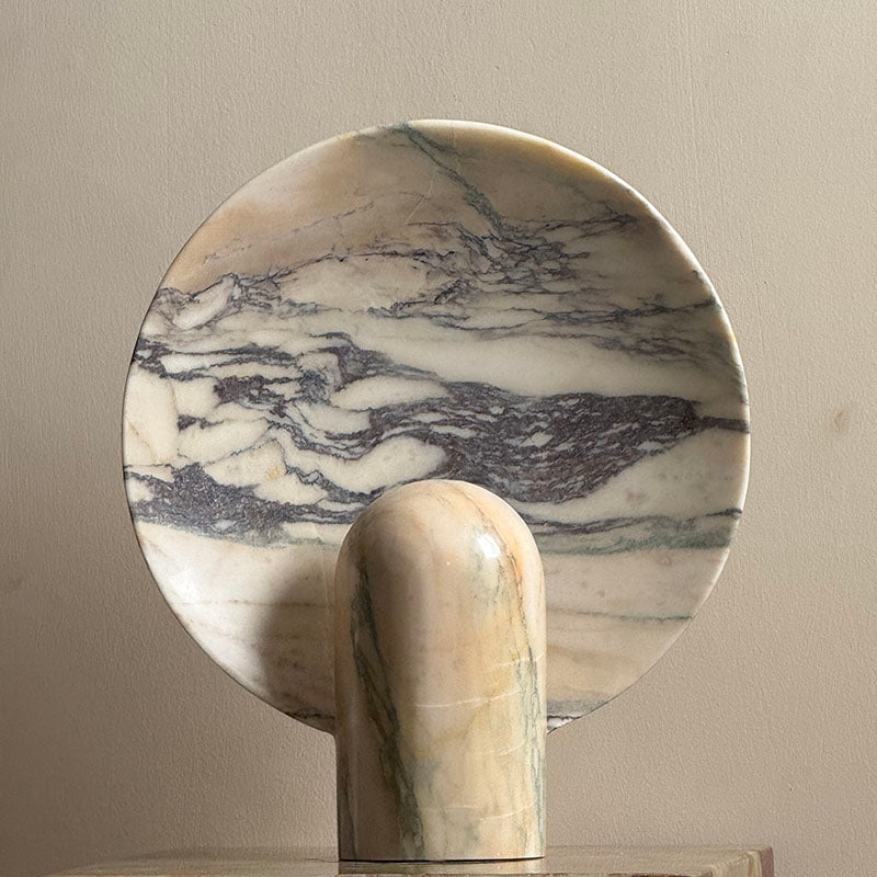 The light brown travertine Fan Table Lamp in a bright, airy room.