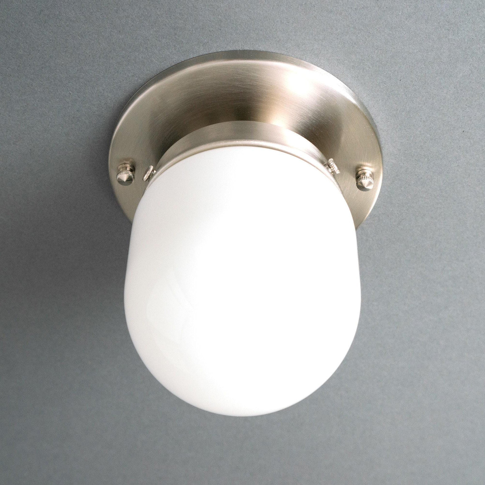 The ceiling lamp installed in a bathroom, demonstrating its versatility.