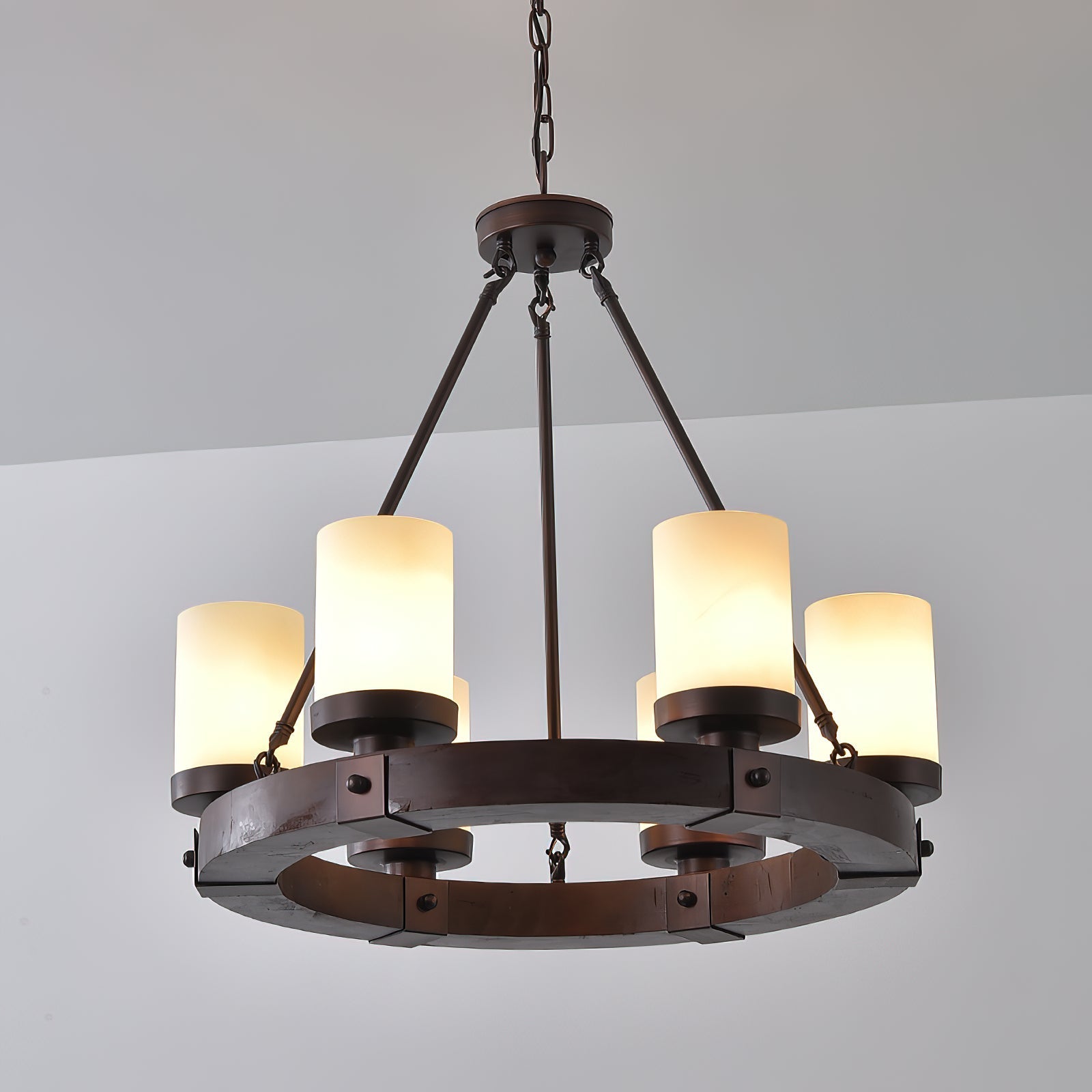 Lifestyle image of the Cabot chandelier over a wooden dining table.