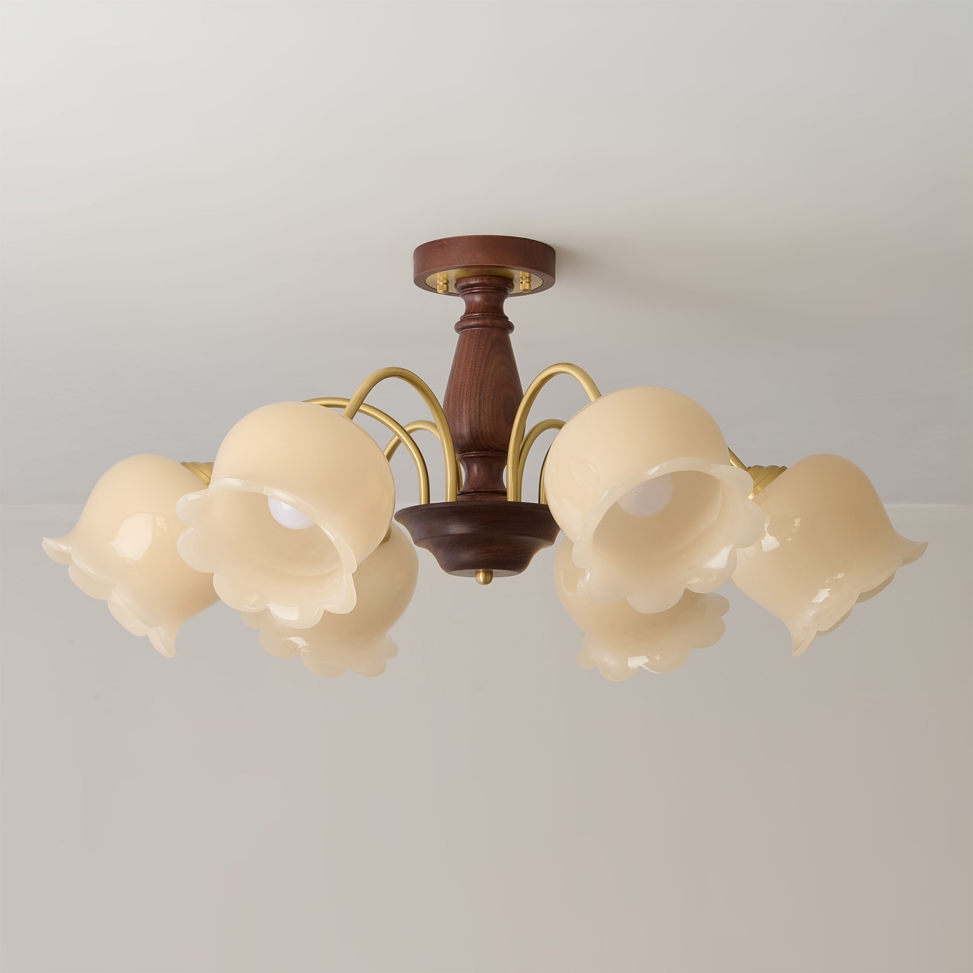 A single cream-colored glass flower shade, showing its delicate texture.