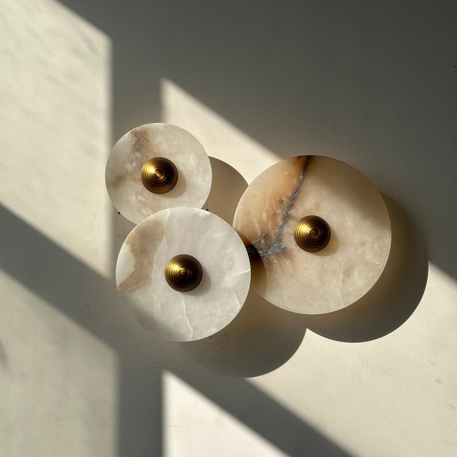 Sconce displayed against a dark wall to highlight its luminosity.