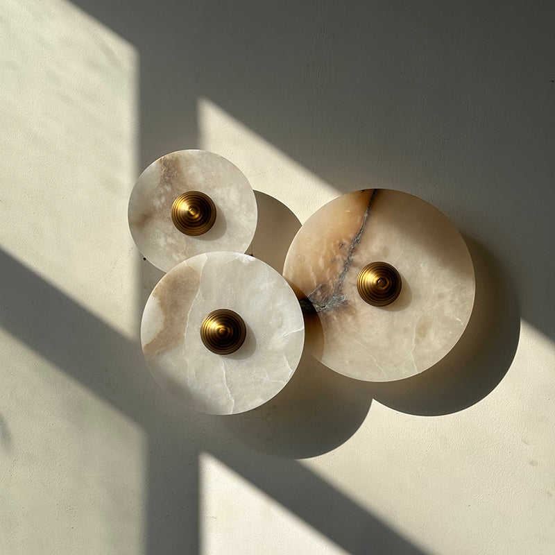 The marble sconce installed in a hallway, providing ambient light.