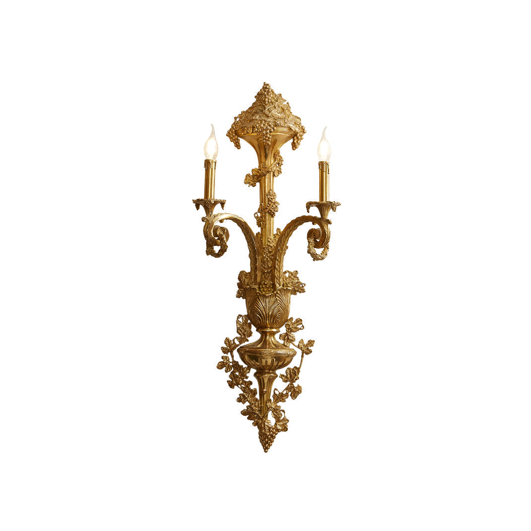 Caldwell Brass Wall Lamp against a neutral wall.
