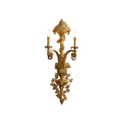 Caldwell Brass Wall Lamp against a neutral wall.