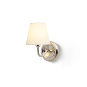 Caleb Starburst Wall Sconce in gold finish against a neutral wall.