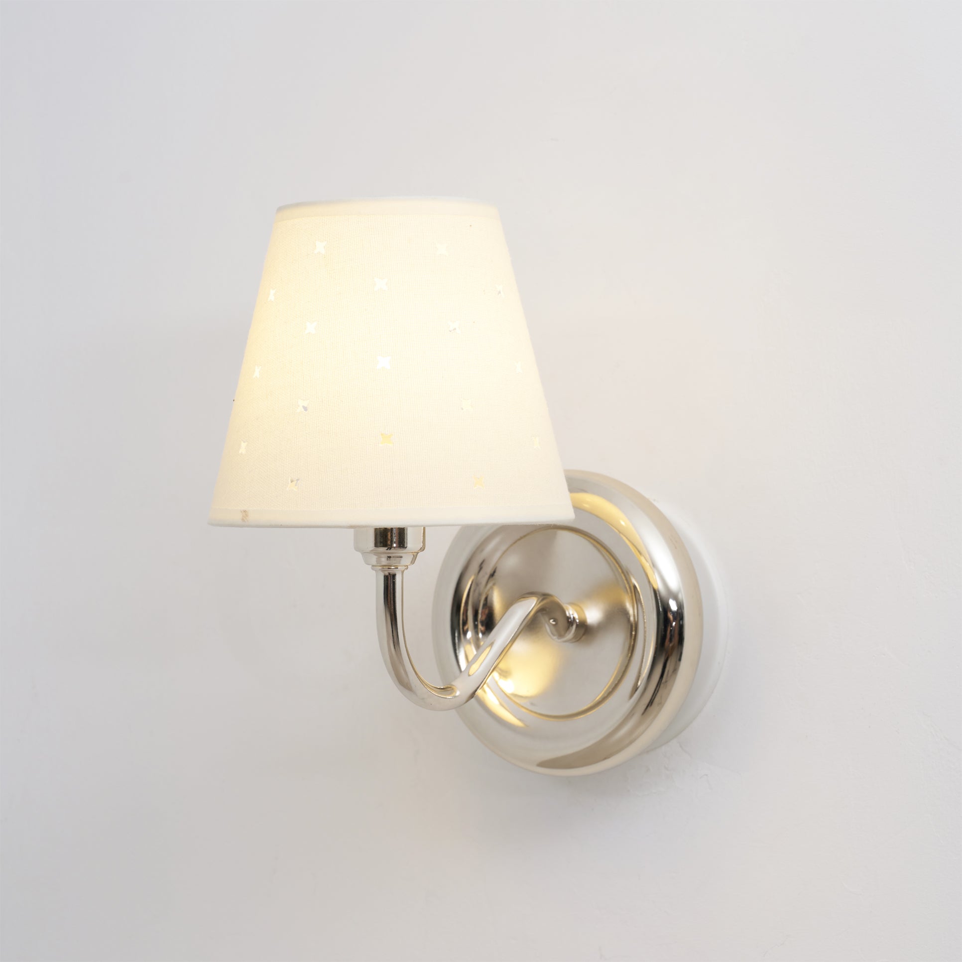 A pair of white and chrome Caleb sconces providing light over a double vanity.