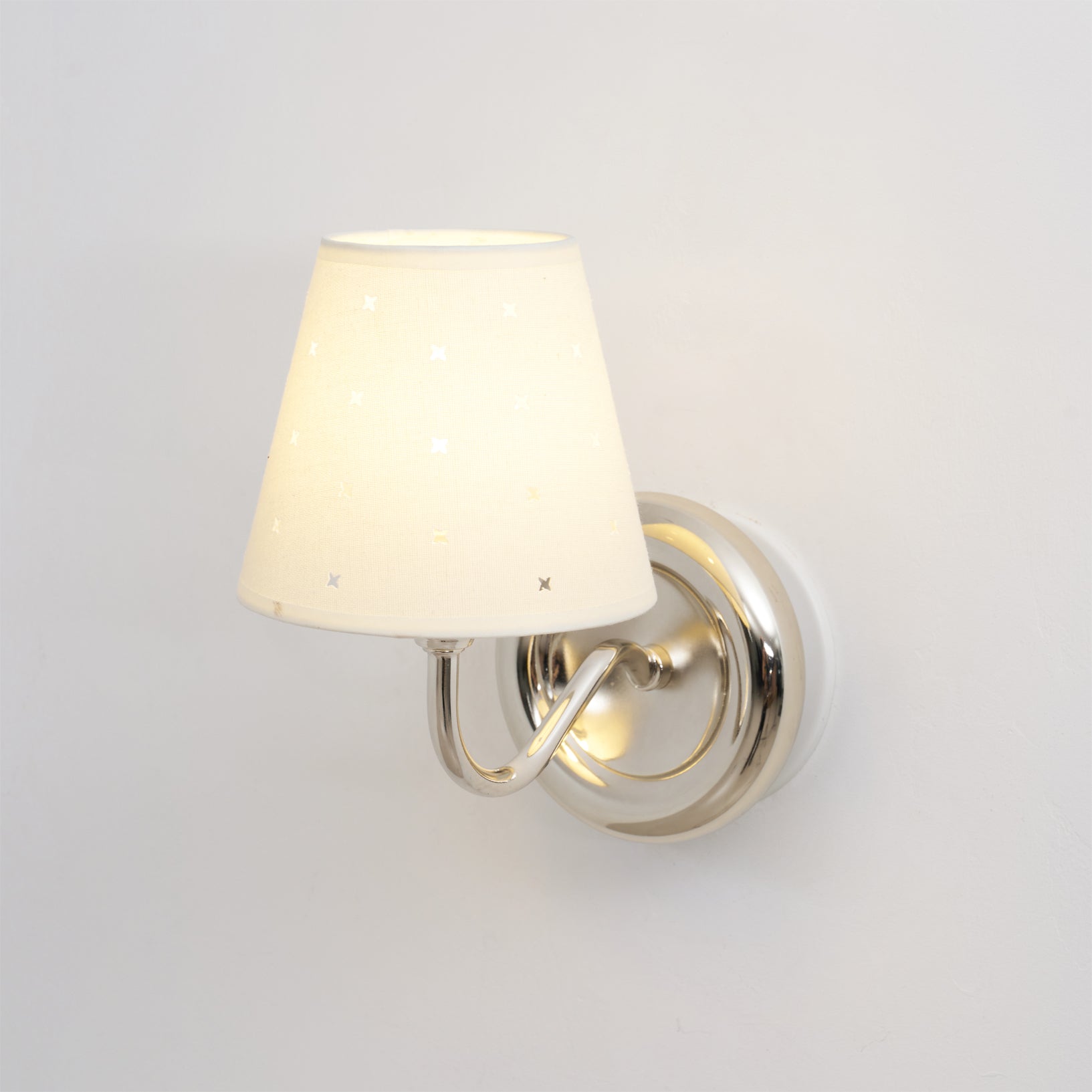 Front view of the white and chrome Caleb Starburst Wall Sconce.