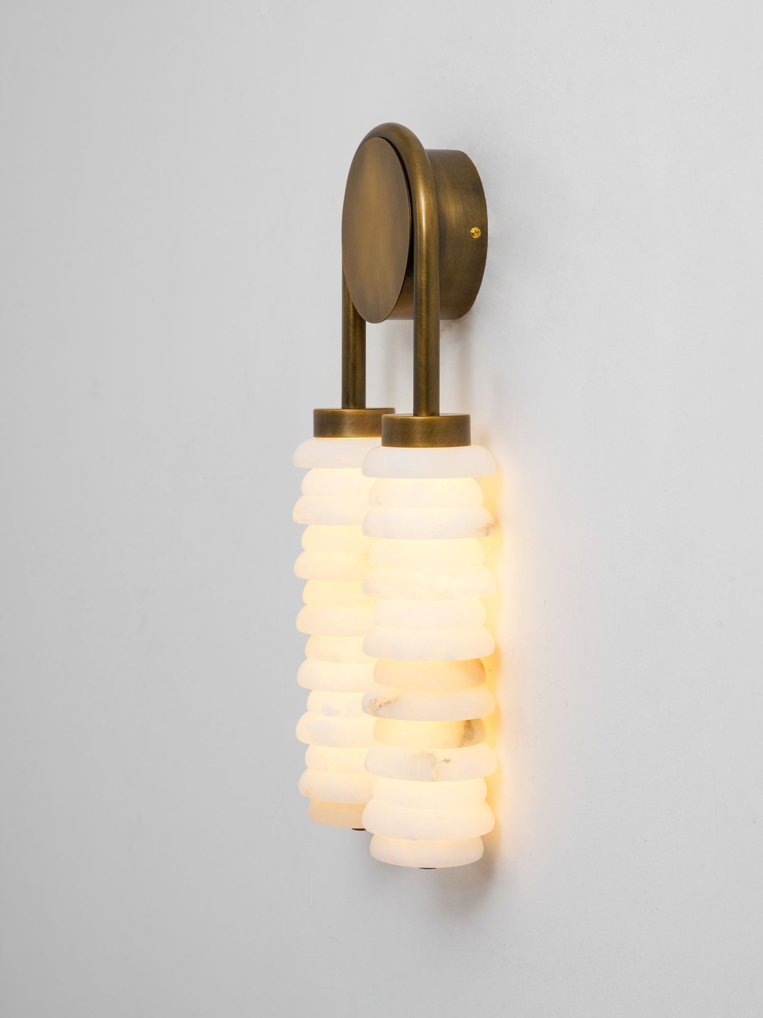 Payson wall lamp paired with modern art on a gallery wall.