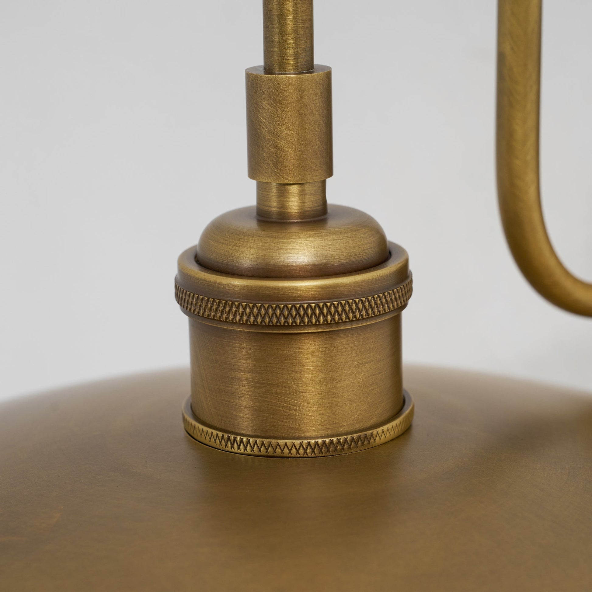 Top-down view of the wall lamp's shade and arm.