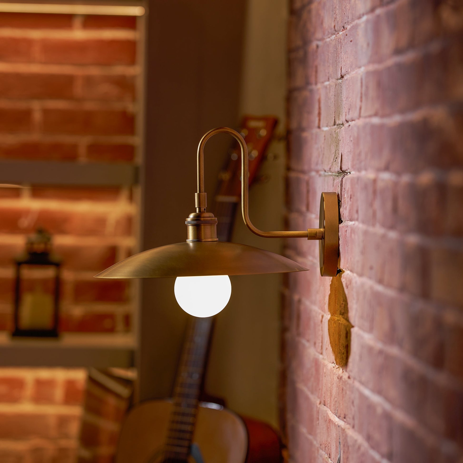 Lifestyle image of the Cantina Wall Lamp in a bedroom setting.