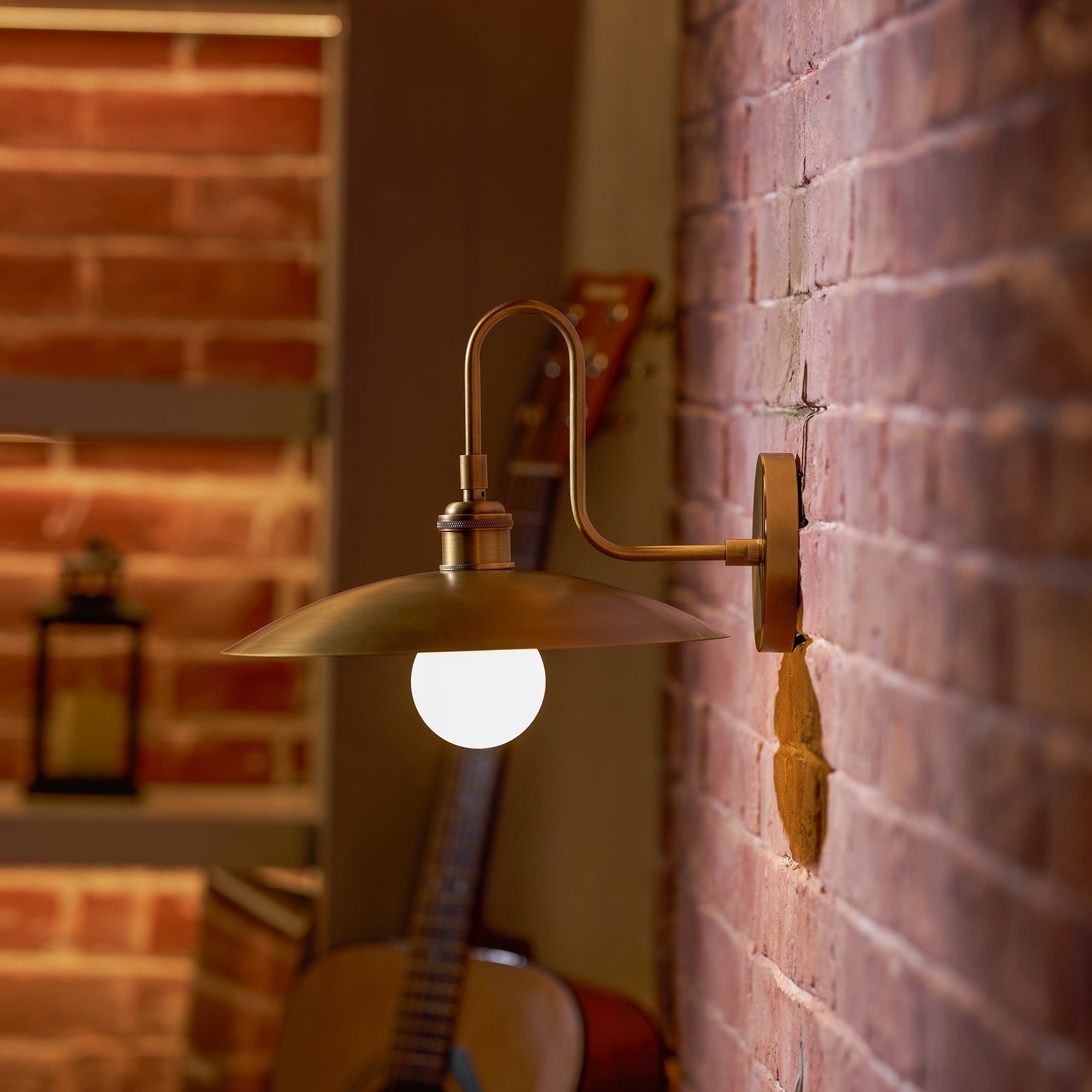 Lifestyle image of the Cantina Wall Lamp in a bedroom setting.