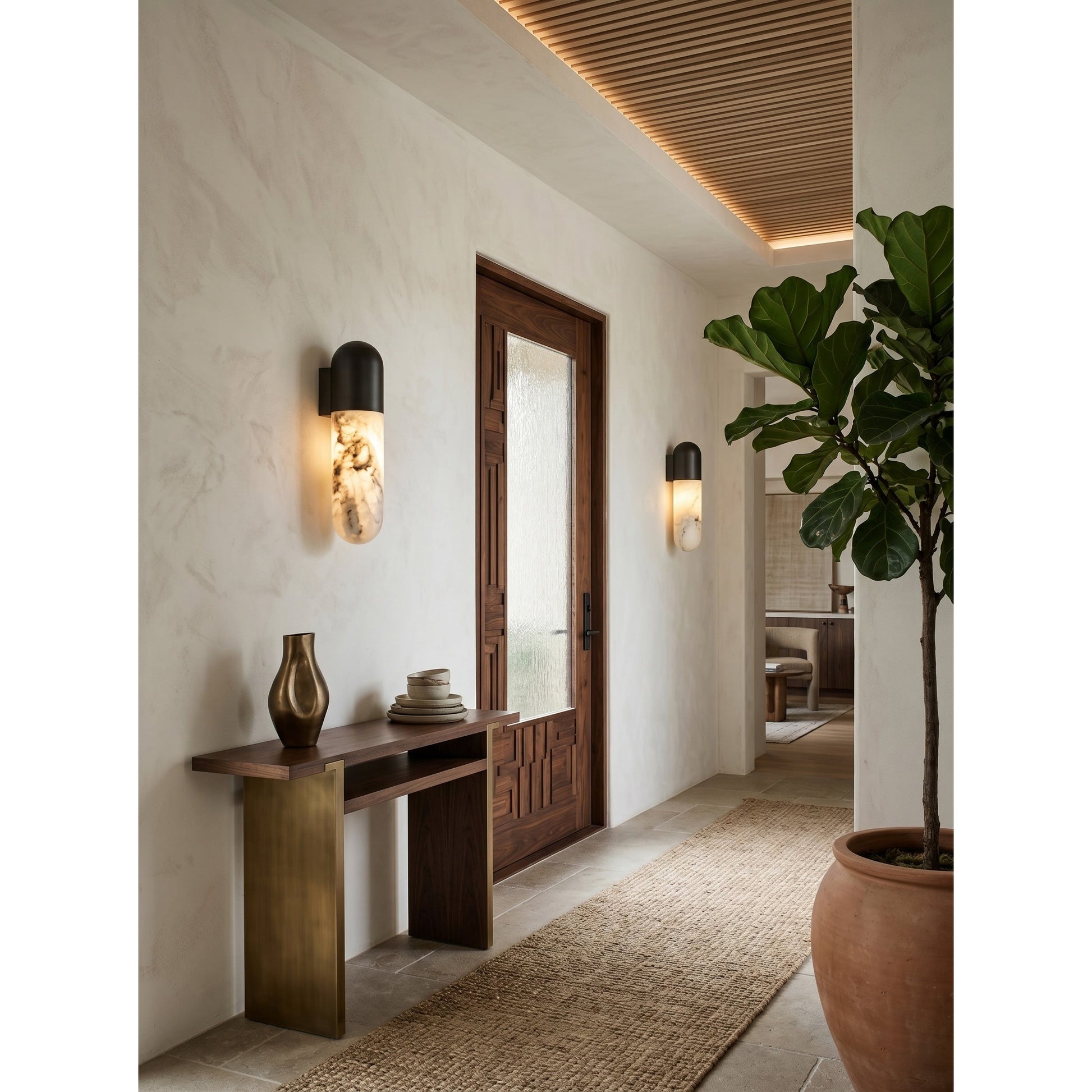 The wall lamp shown illuminated, casting a warm, soft glow.