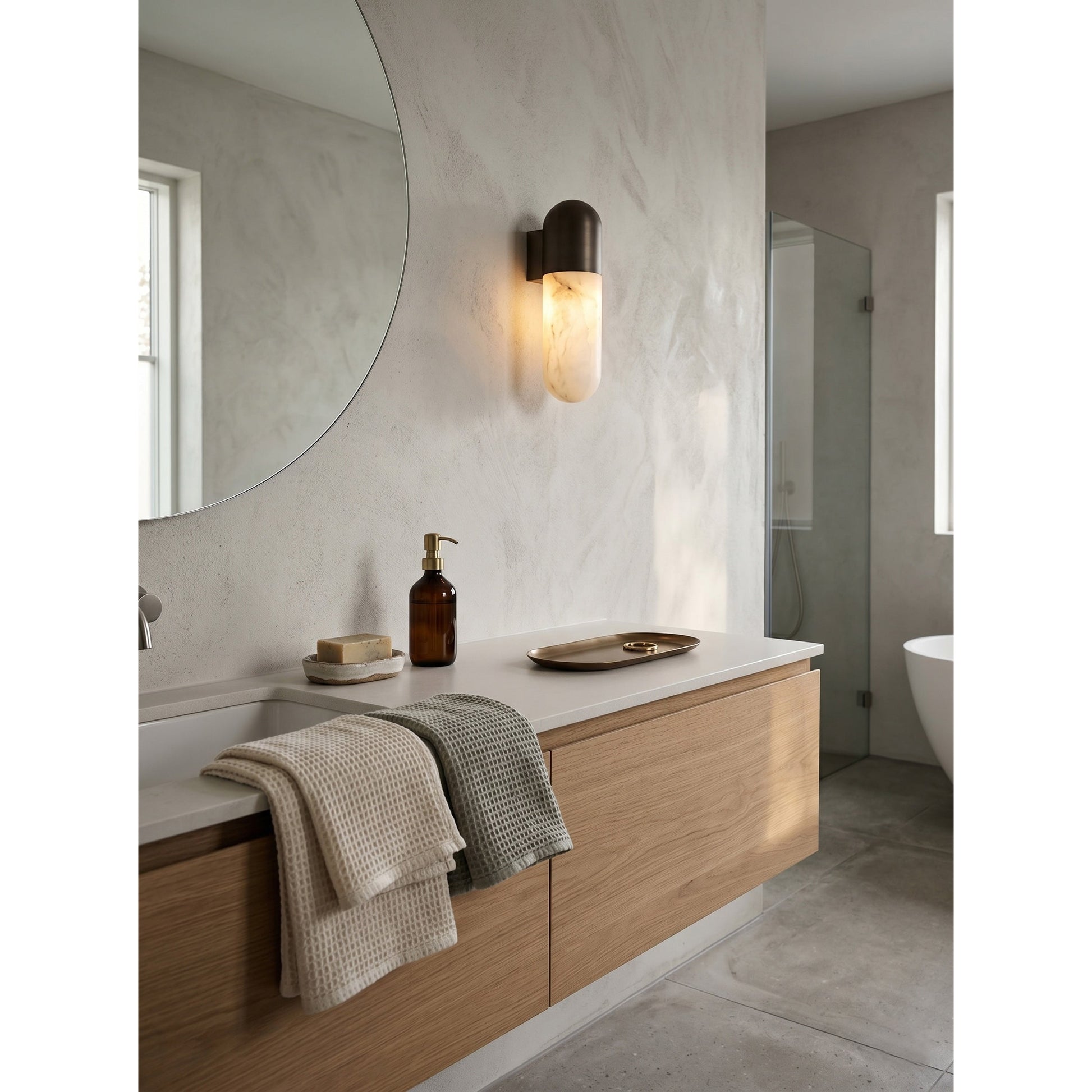 Capsule Alabaster Wall Lamp with a brass finish.