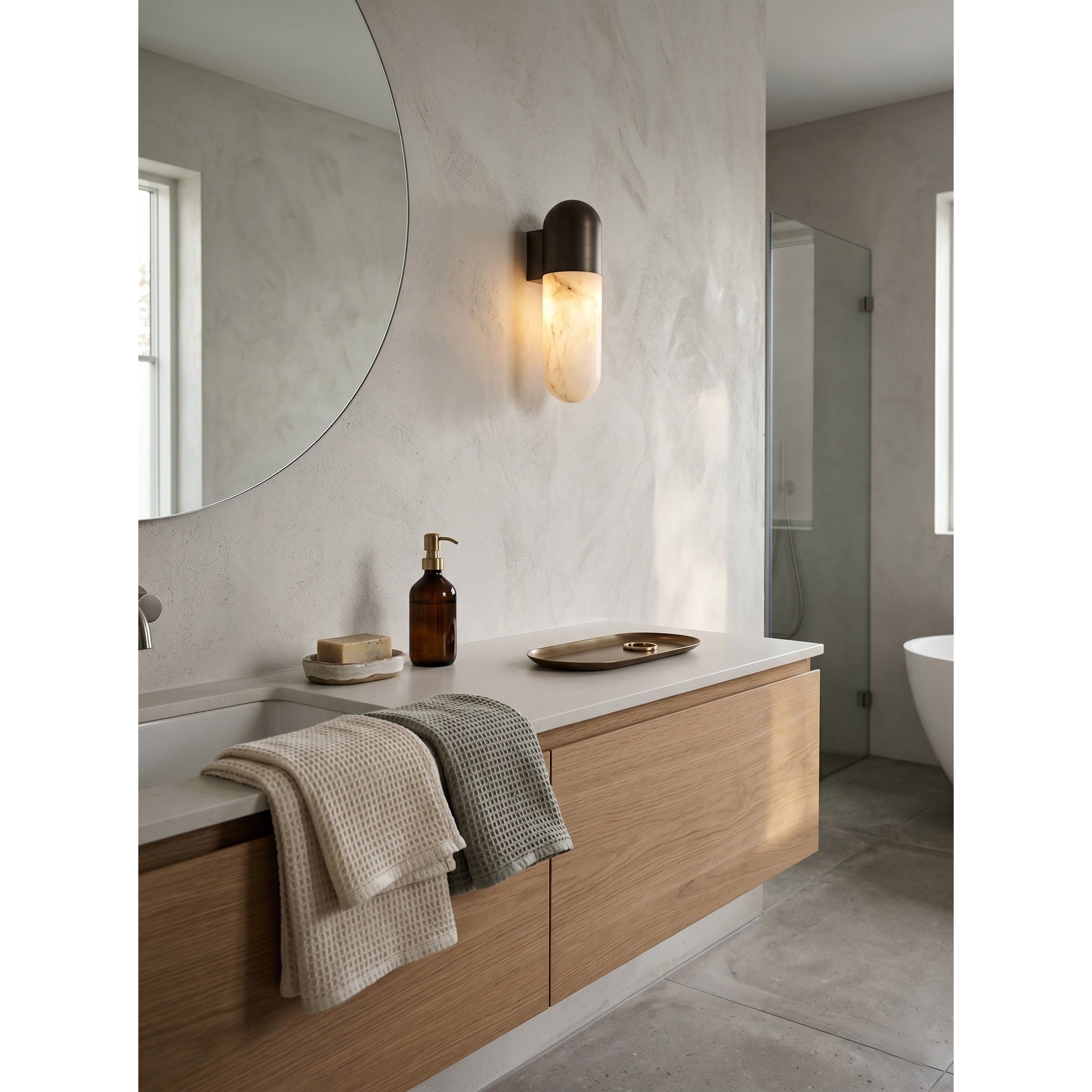 Capsule Alabaster Wall Lamp with a brass finish.