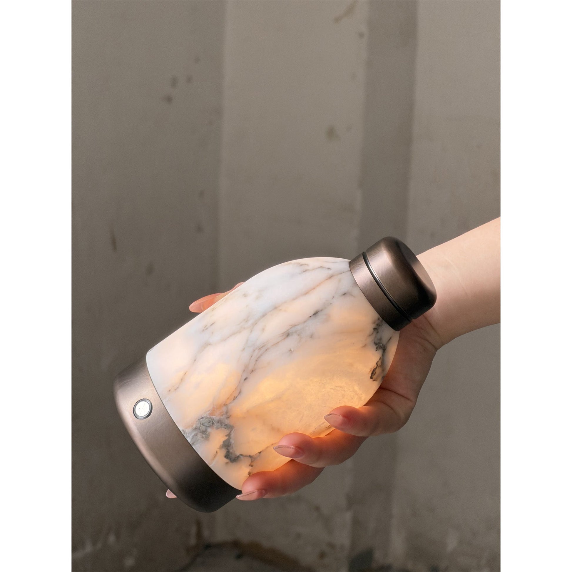 White Capsule Marble Table Lamp on a marble surface.