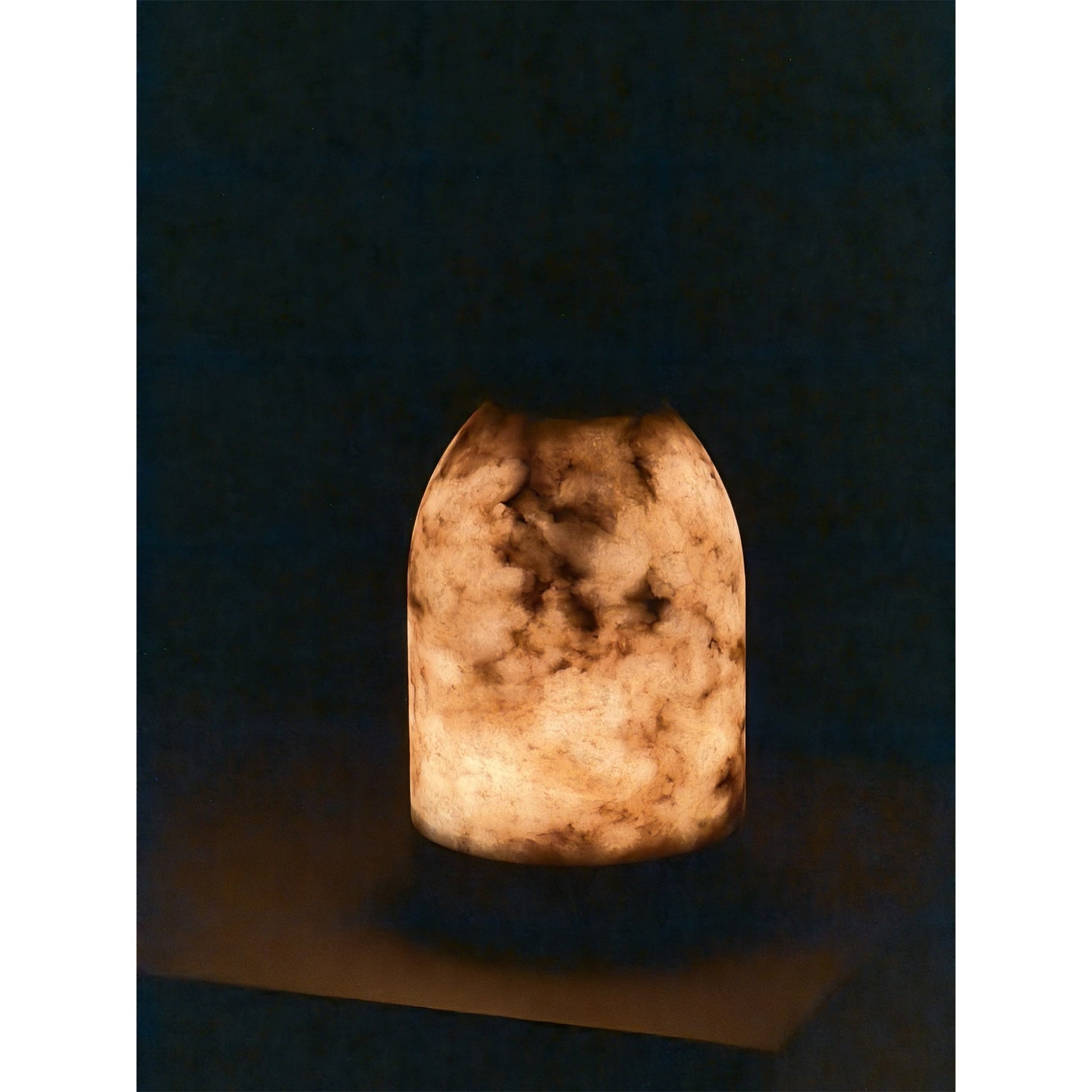 Angled view of the white lamp, highlighting its capsule shape.
