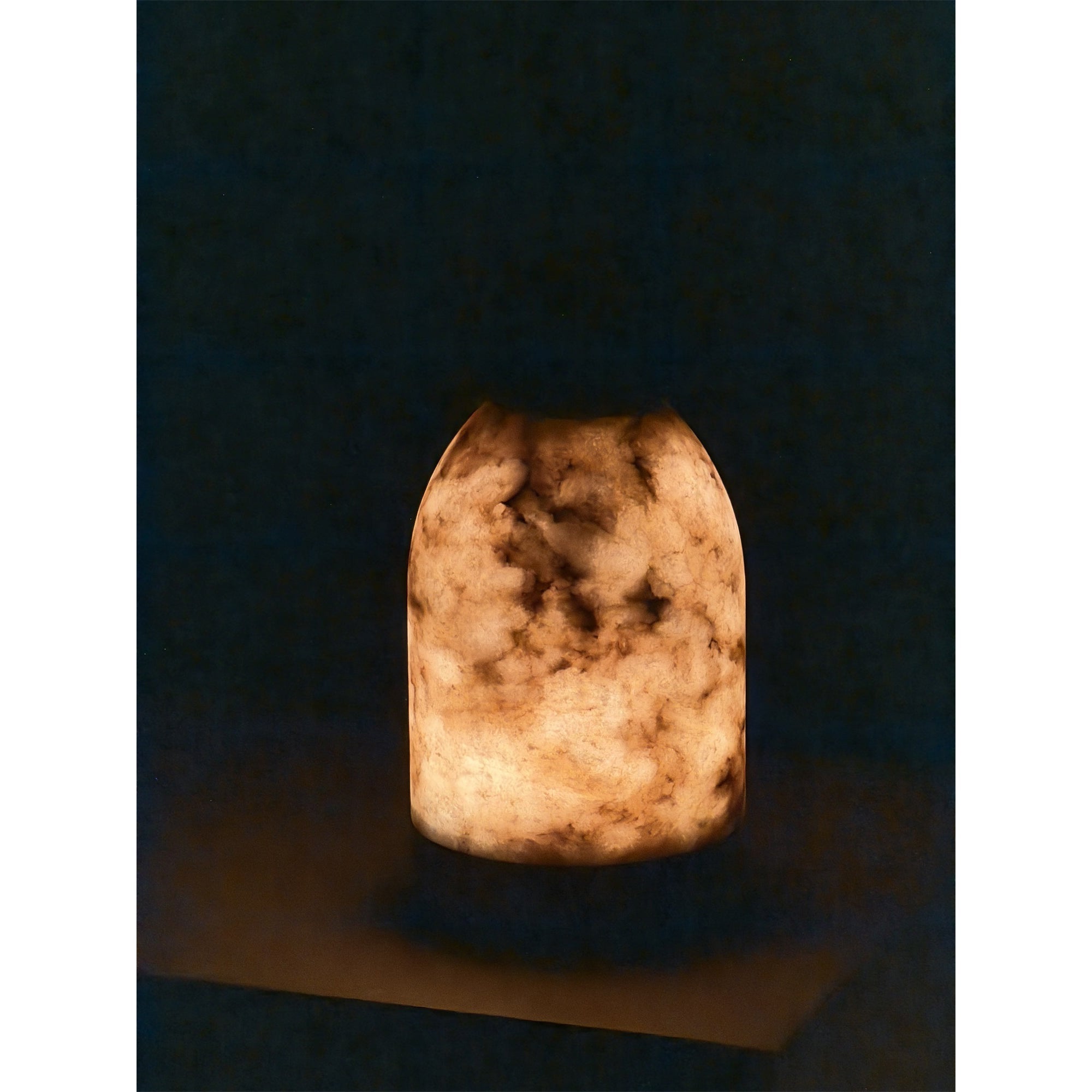 Angled view of the white lamp, highlighting its capsule shape.
