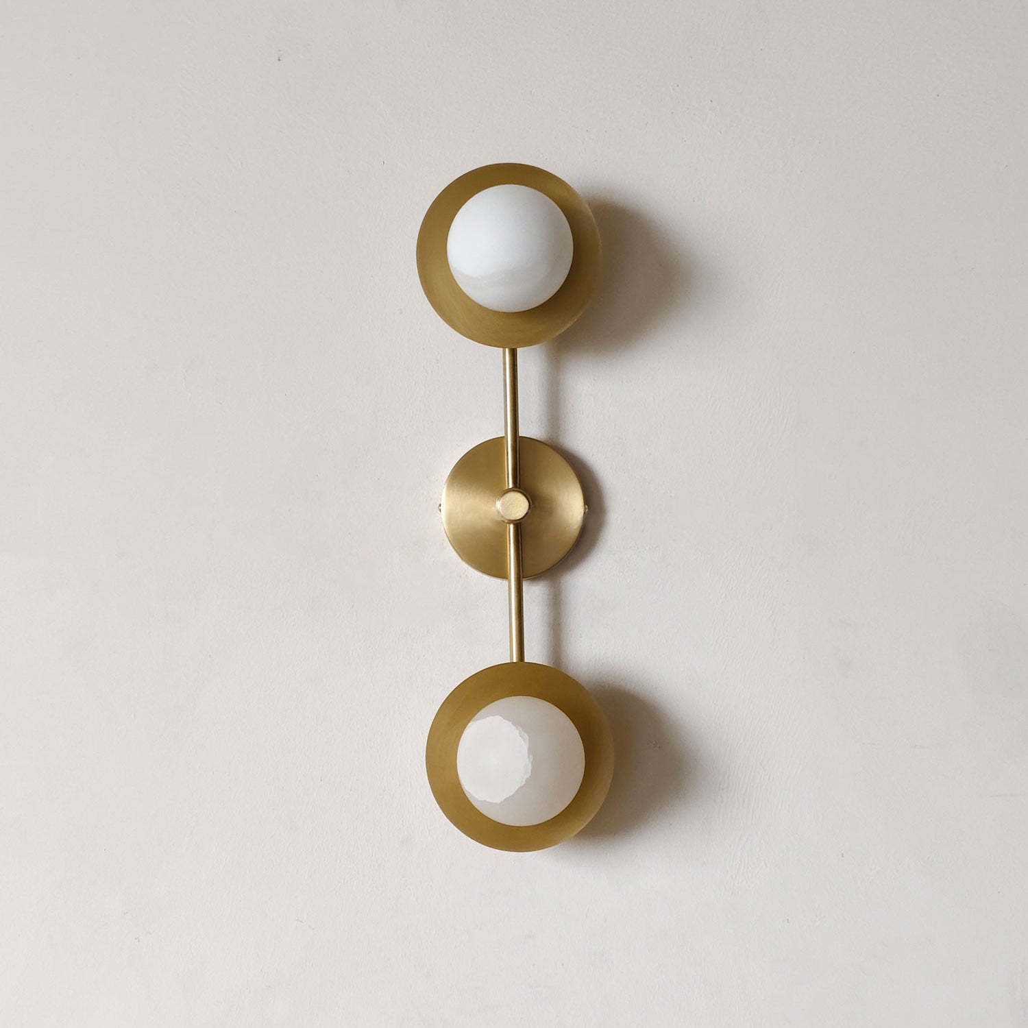 Detail shot of the brass fixture and mounting hardware of the wall lamp.