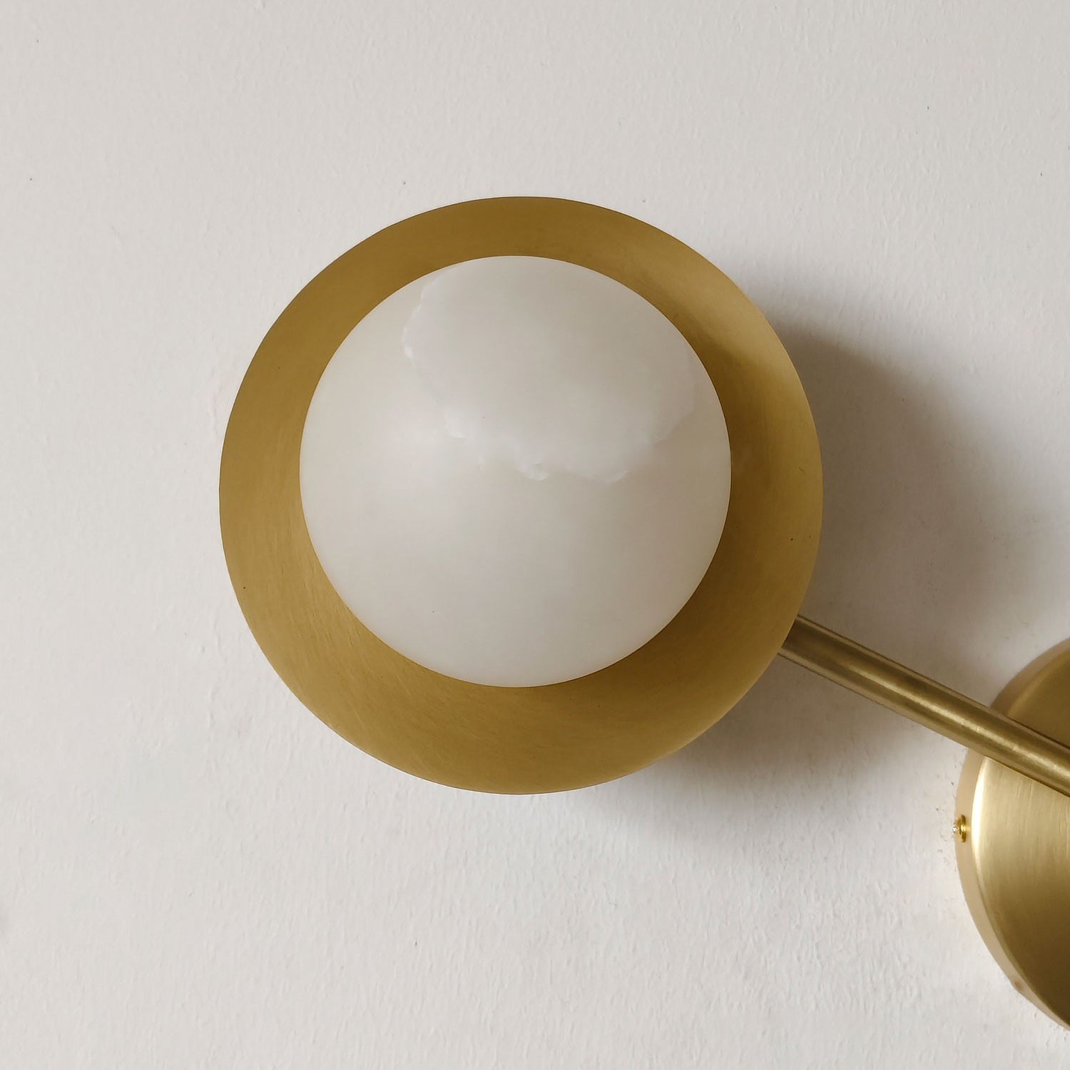 The Cara Wall Lamp as a statement piece in a minimalist interior setting.