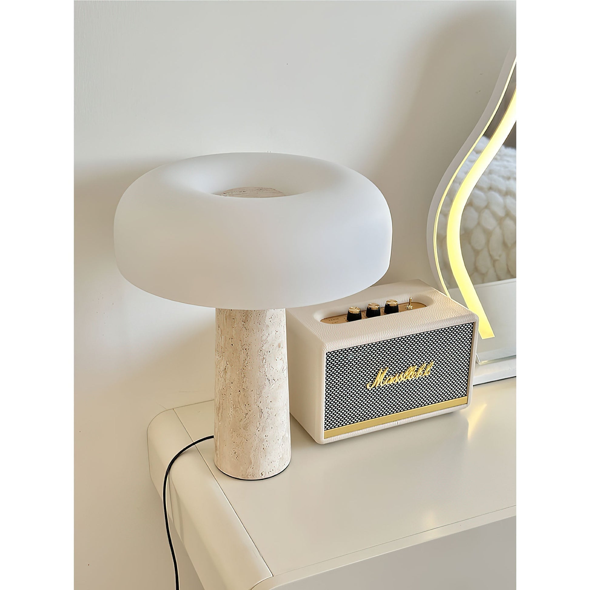 Carla Table Lamp against a neutral wall.