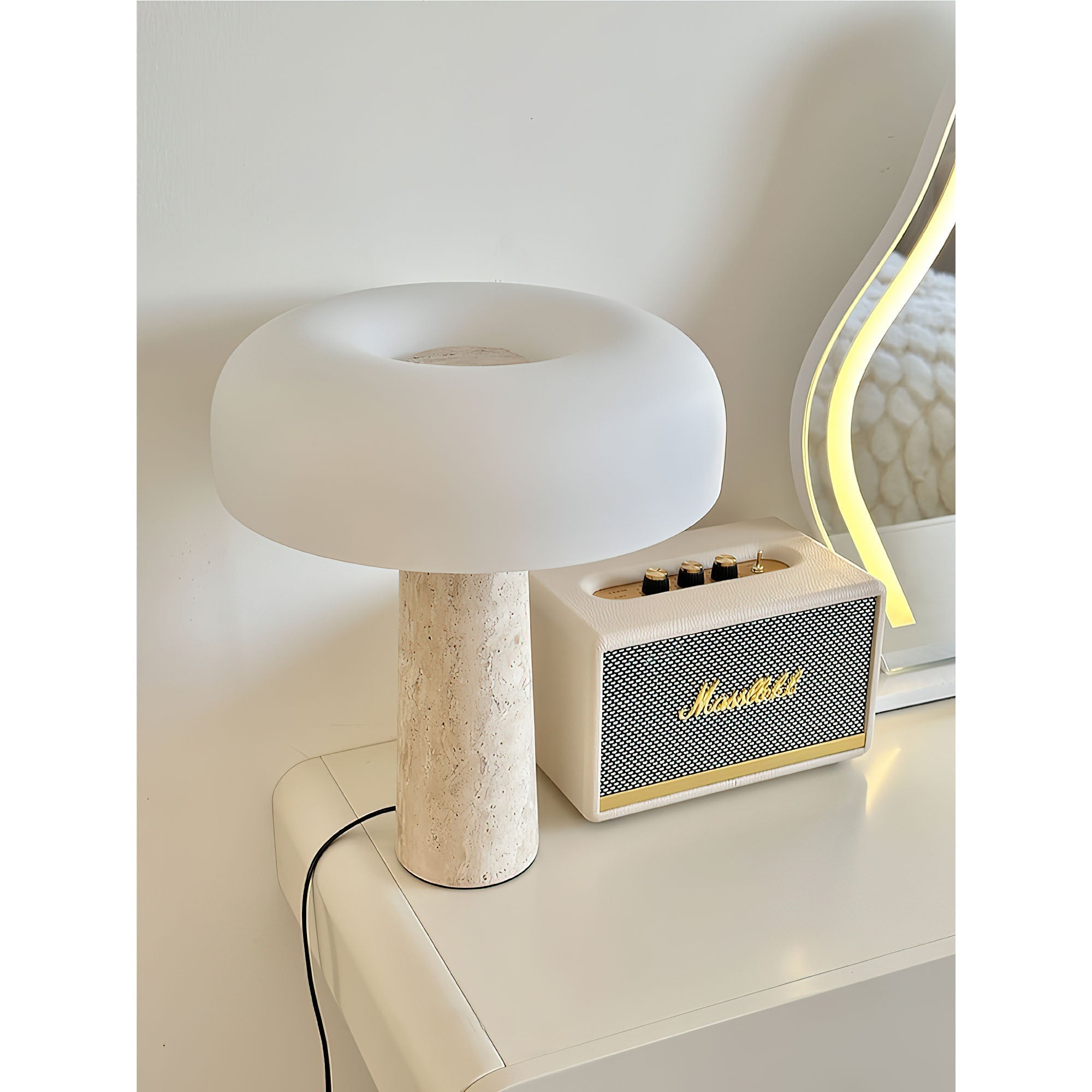 Carla Table Lamp against a neutral wall.