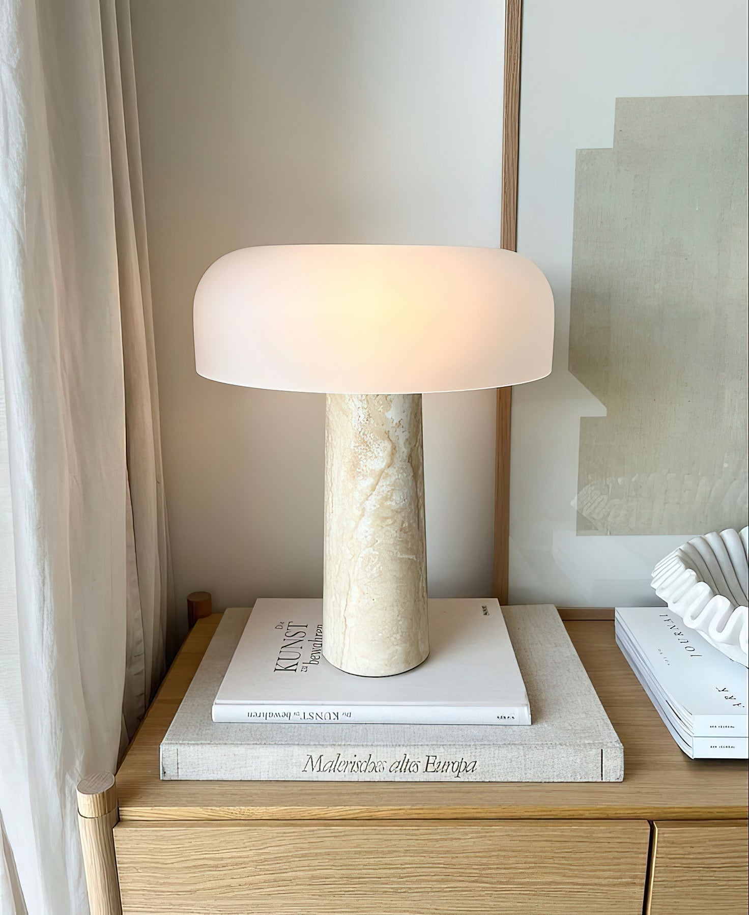 Close-up view of the Carla Table Lamp's natural travertine stone base.