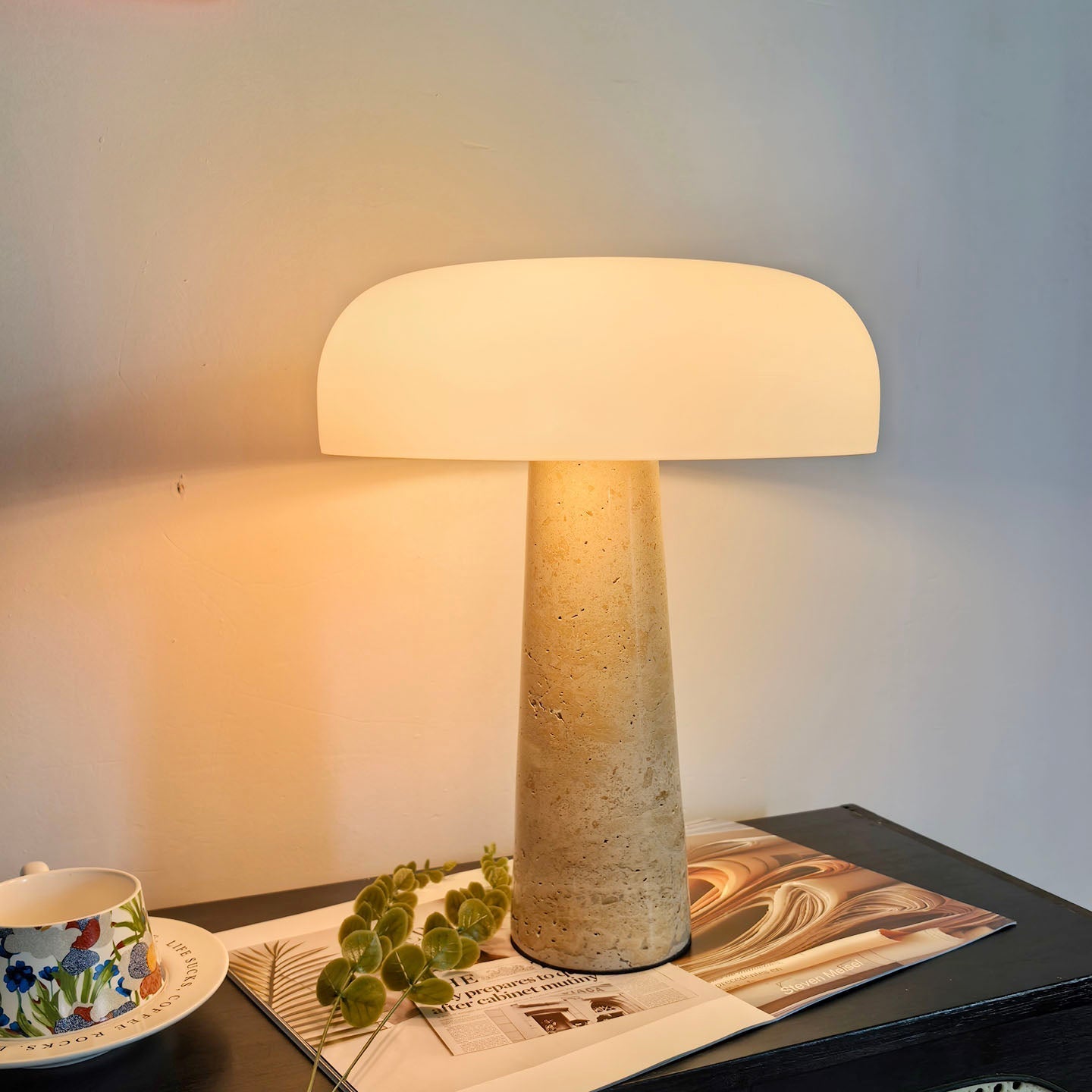 Top-down view of the glass lampshade and travertine body.