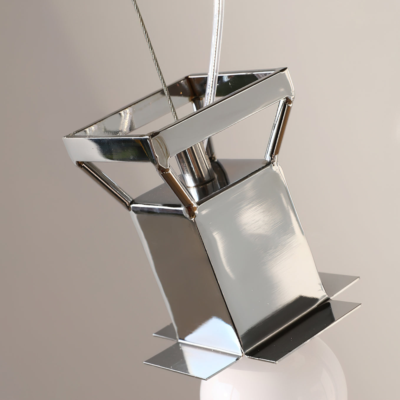 Detail shot of the sleek metal fixture supporting the glass shade.