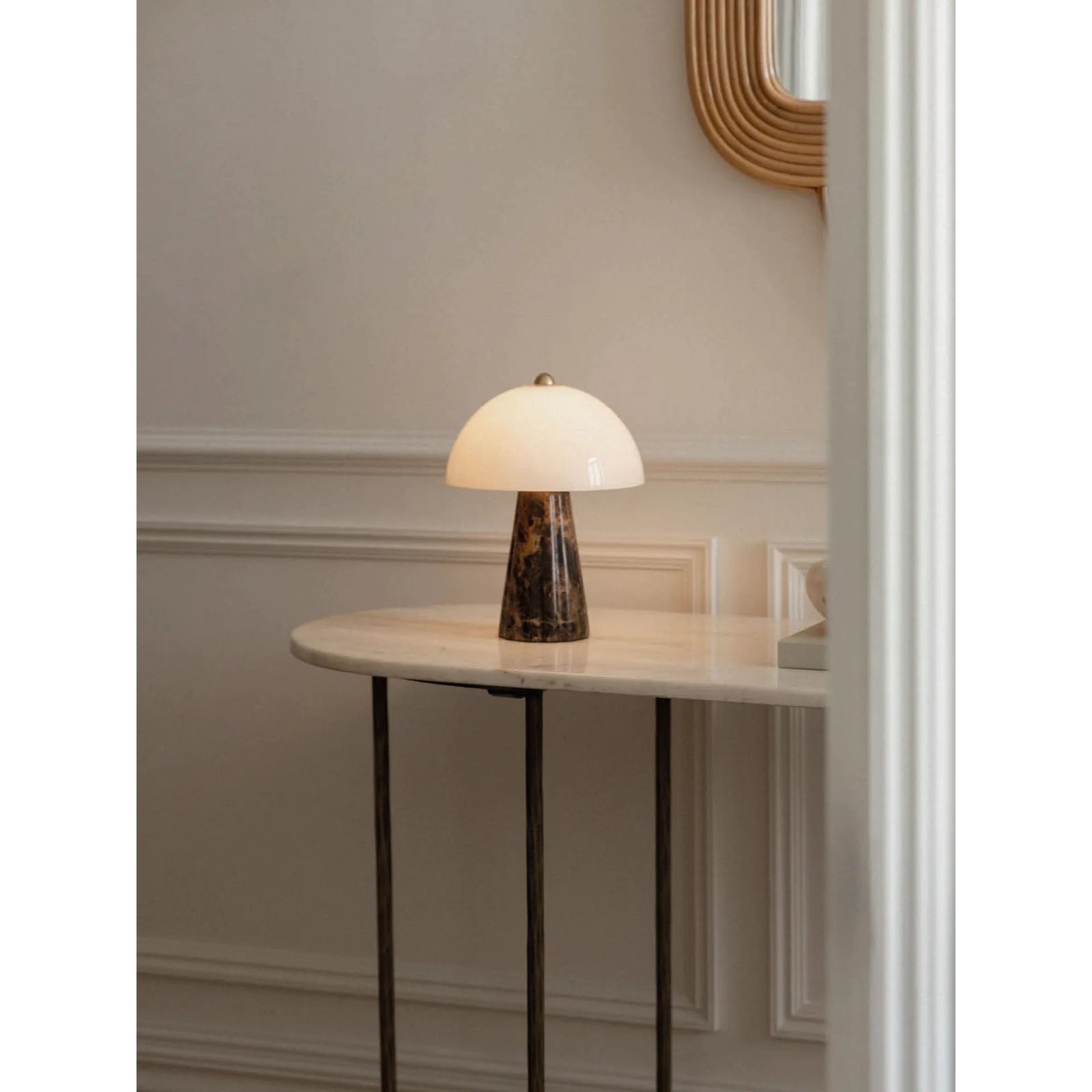 The Carme Table Lamp illuminated, casting a warm, ambient light.