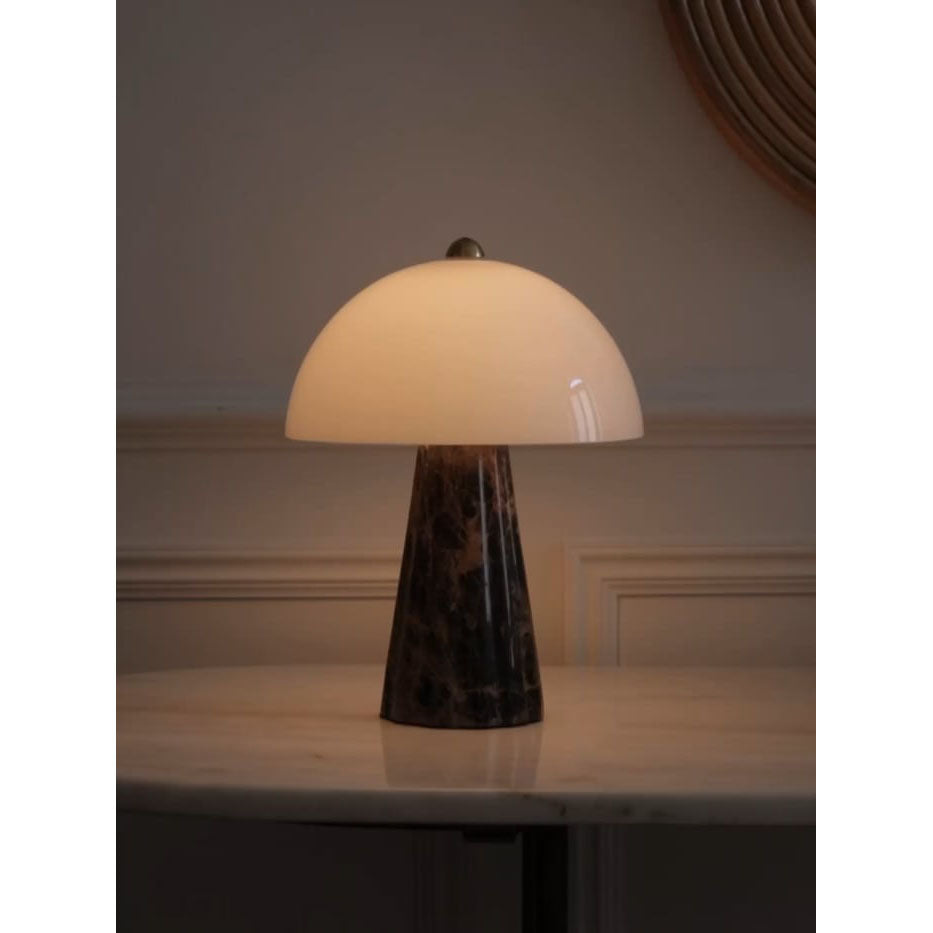 Carme Table Lamp with a white marble body and glass shade.