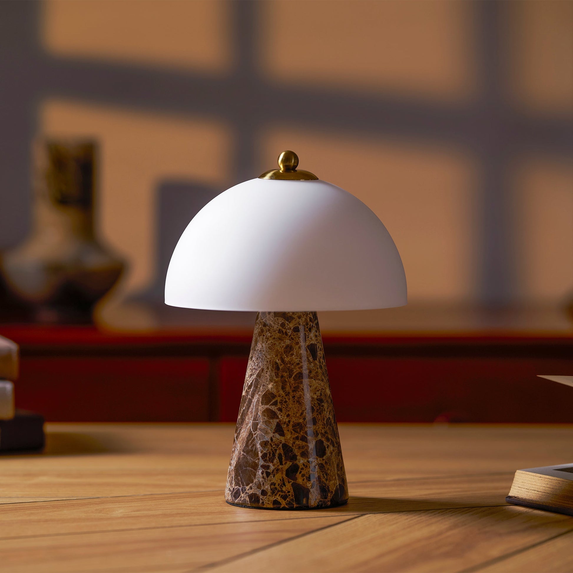 The Carme Table Lamp shown on a modern nightstand.