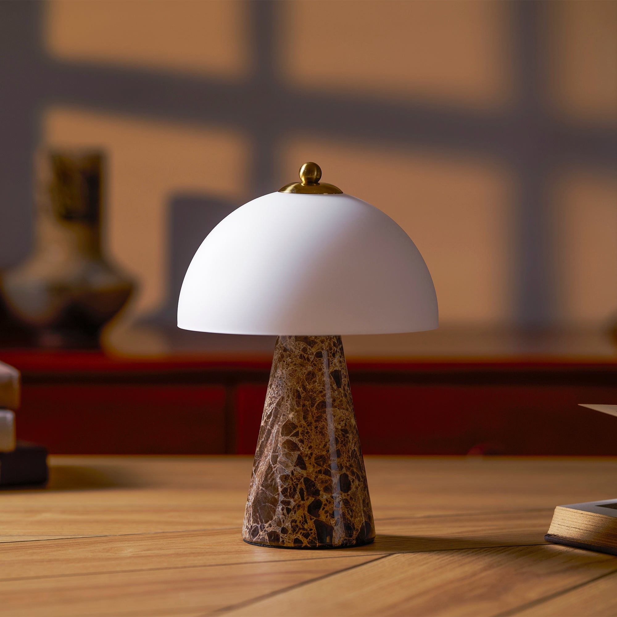 The Carme Table Lamp shown on a modern nightstand.