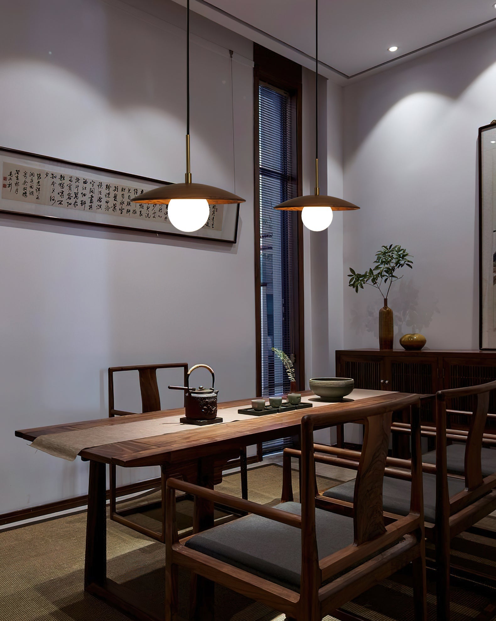Lifestyle image of the Caroll Pendant Light in a dining area.