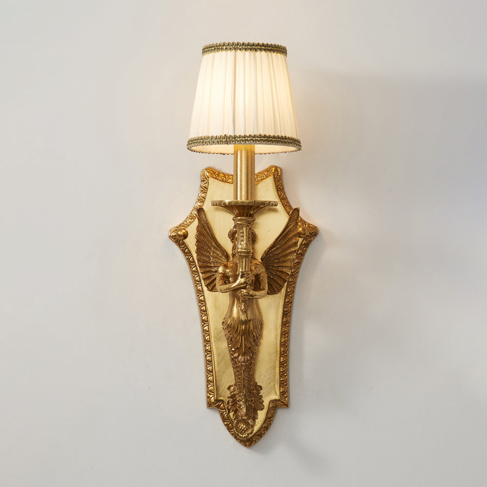 Lit view of the wall lamp, showing light diffusion through the shade.