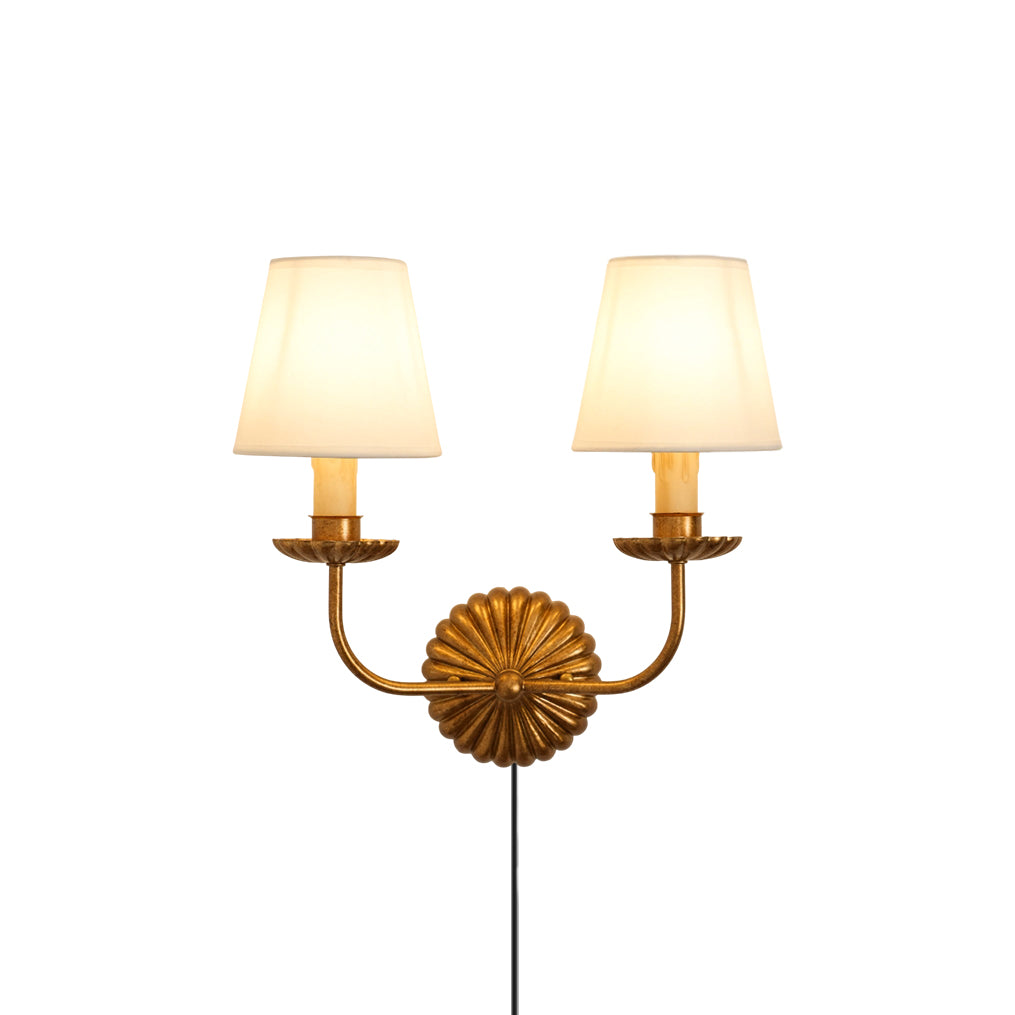 Front view of the antique gold fluted-rosette plug-in wall sconce.