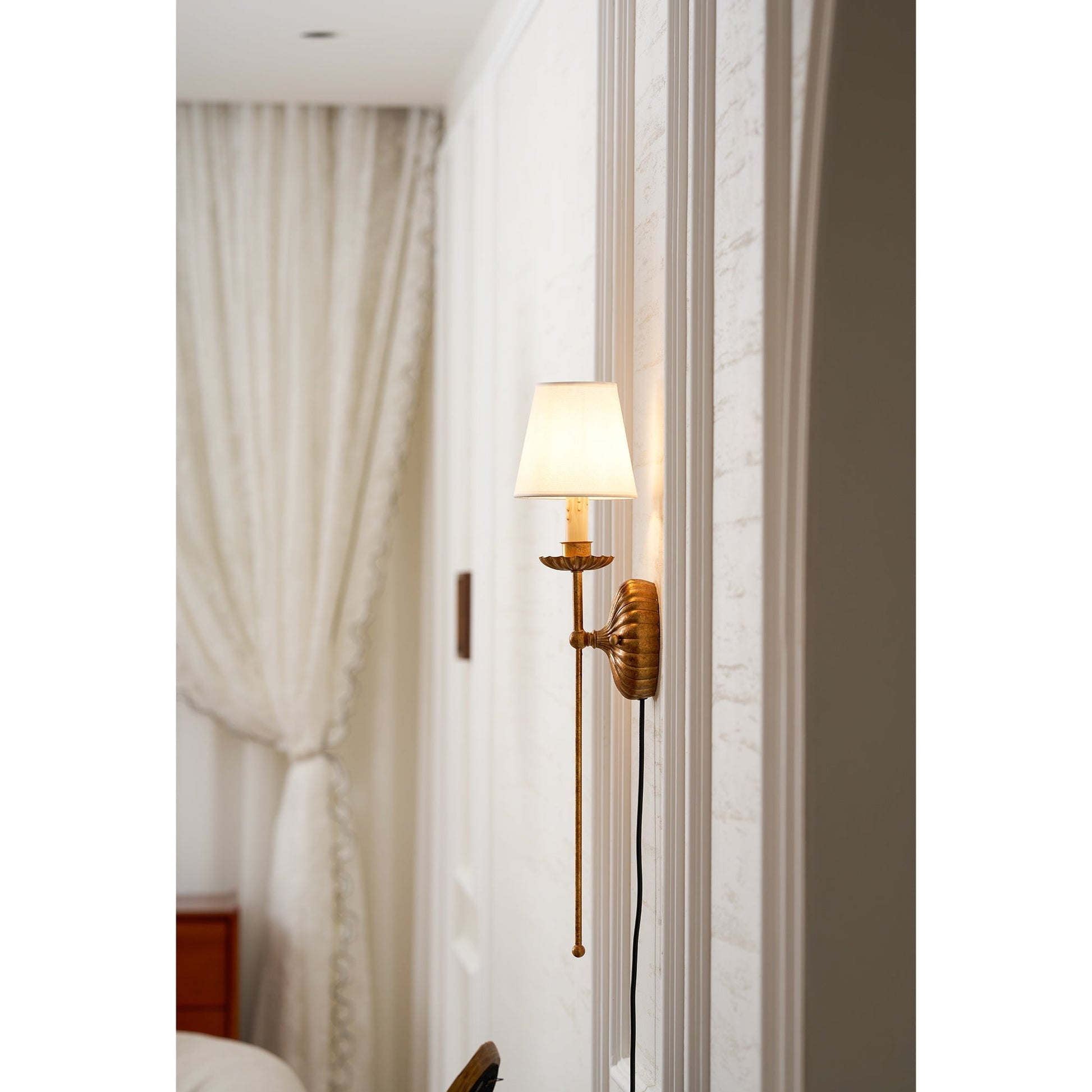 White wall sconce installed in a modern hallway.