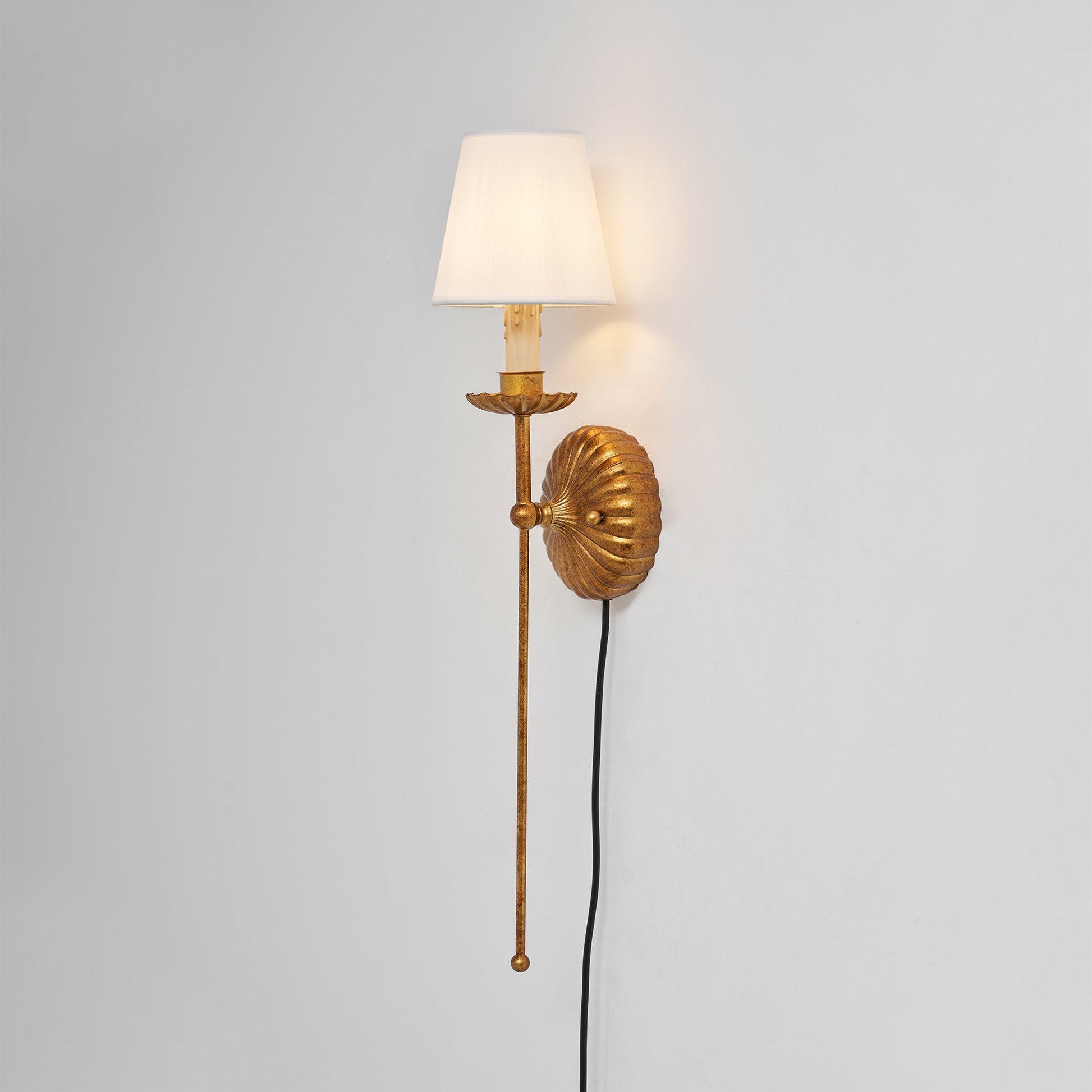 The wall sconce shown unlit, highlighting its sculptural form.