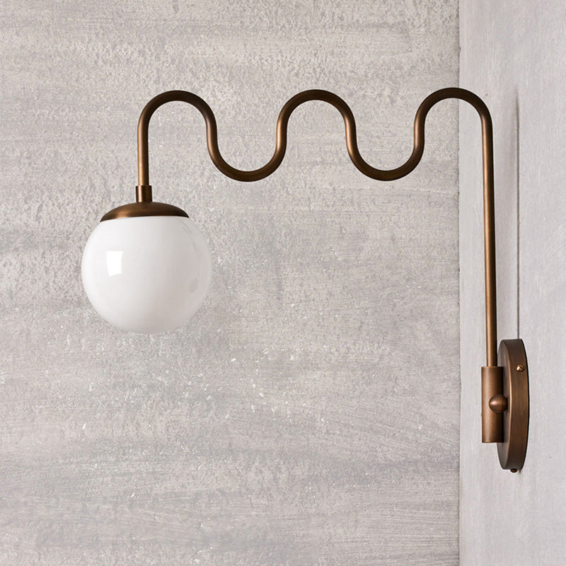 Cecil Wall Sconce turned on, casting a warm glow.